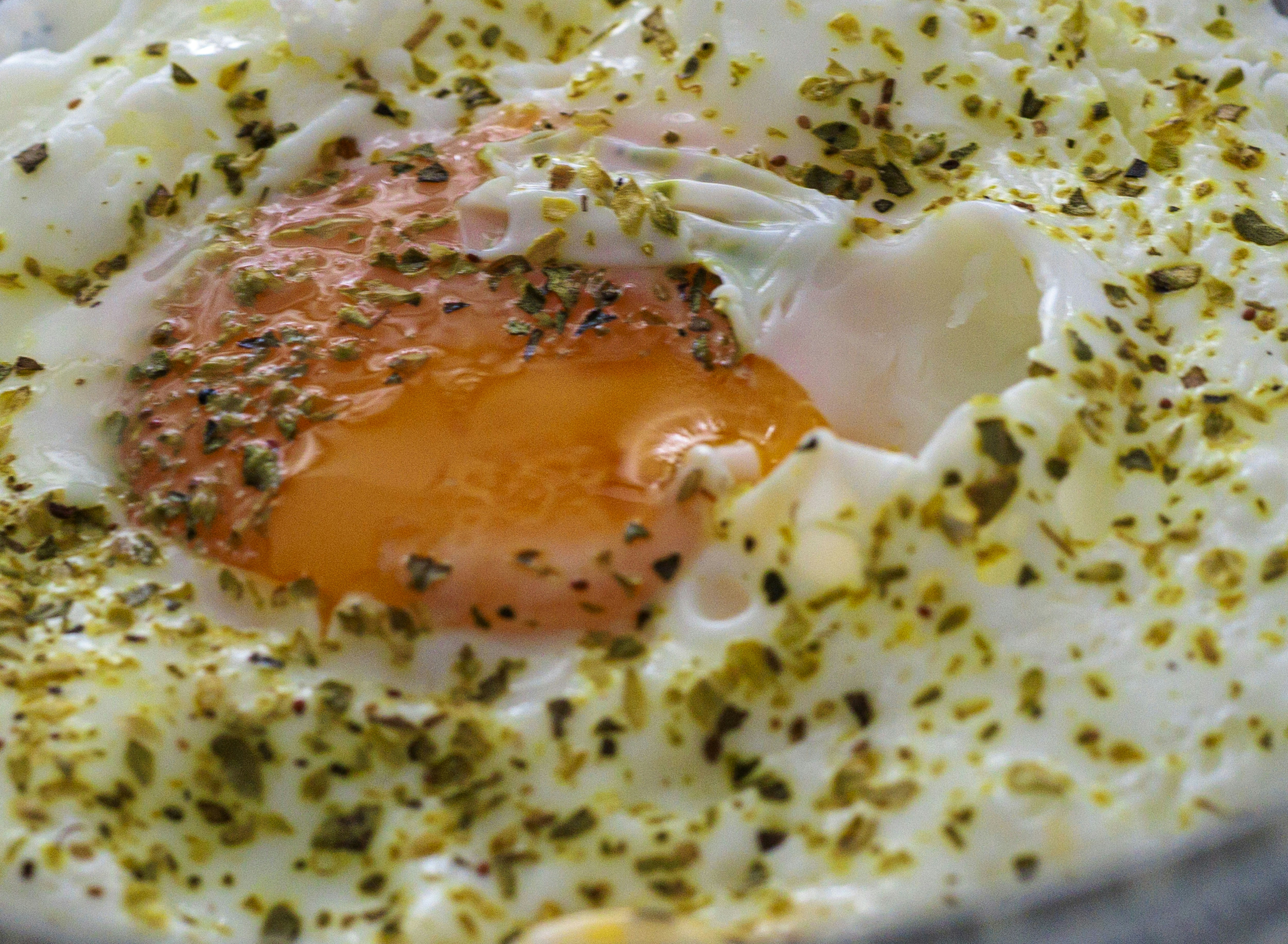 Fried egg with herbs close up
