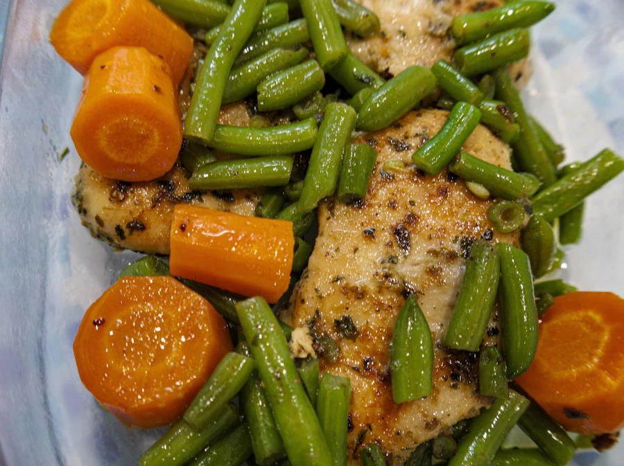 Cooked chicken breast with carrots and green beans