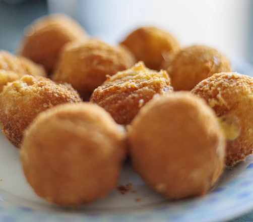 Golden fried cheese balls on a plate