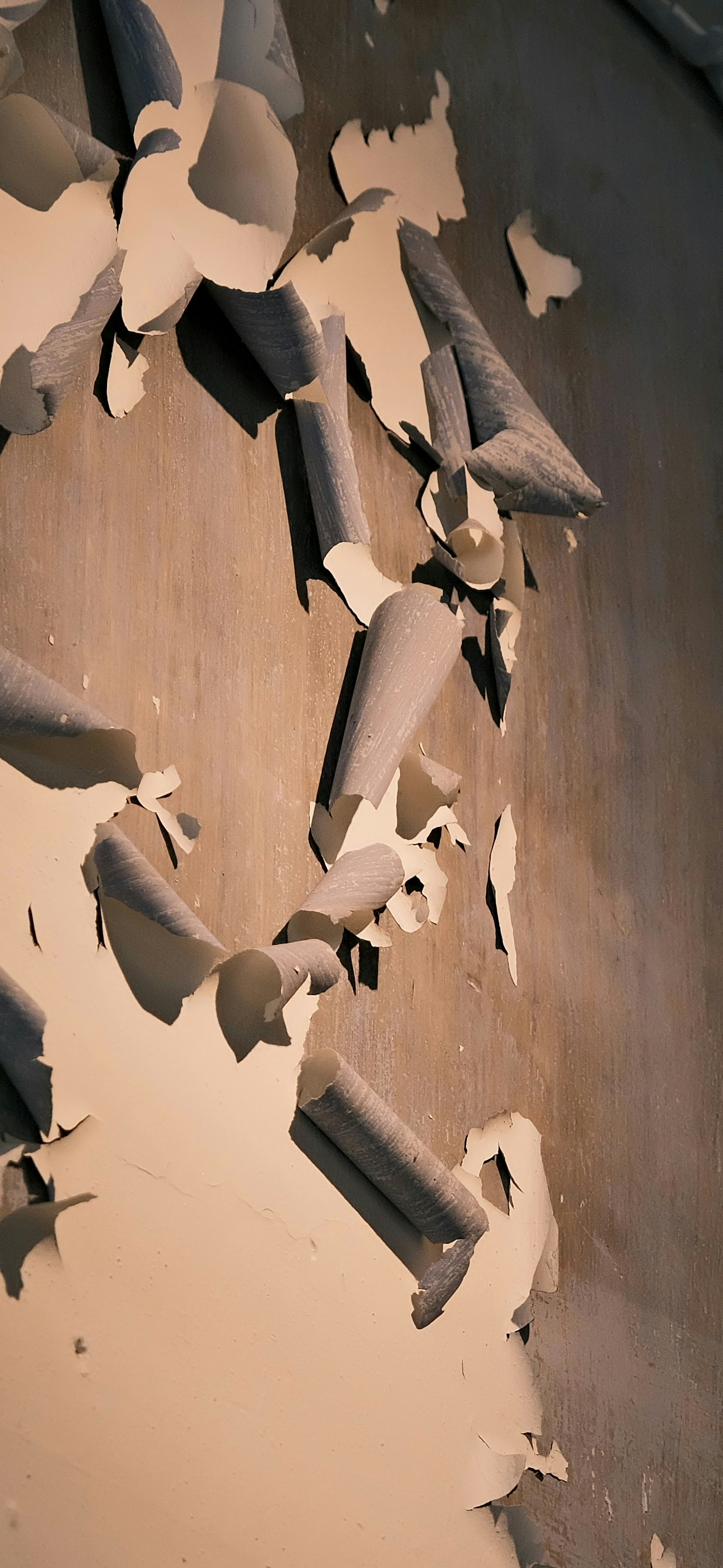 Peeling paint on a textured wall