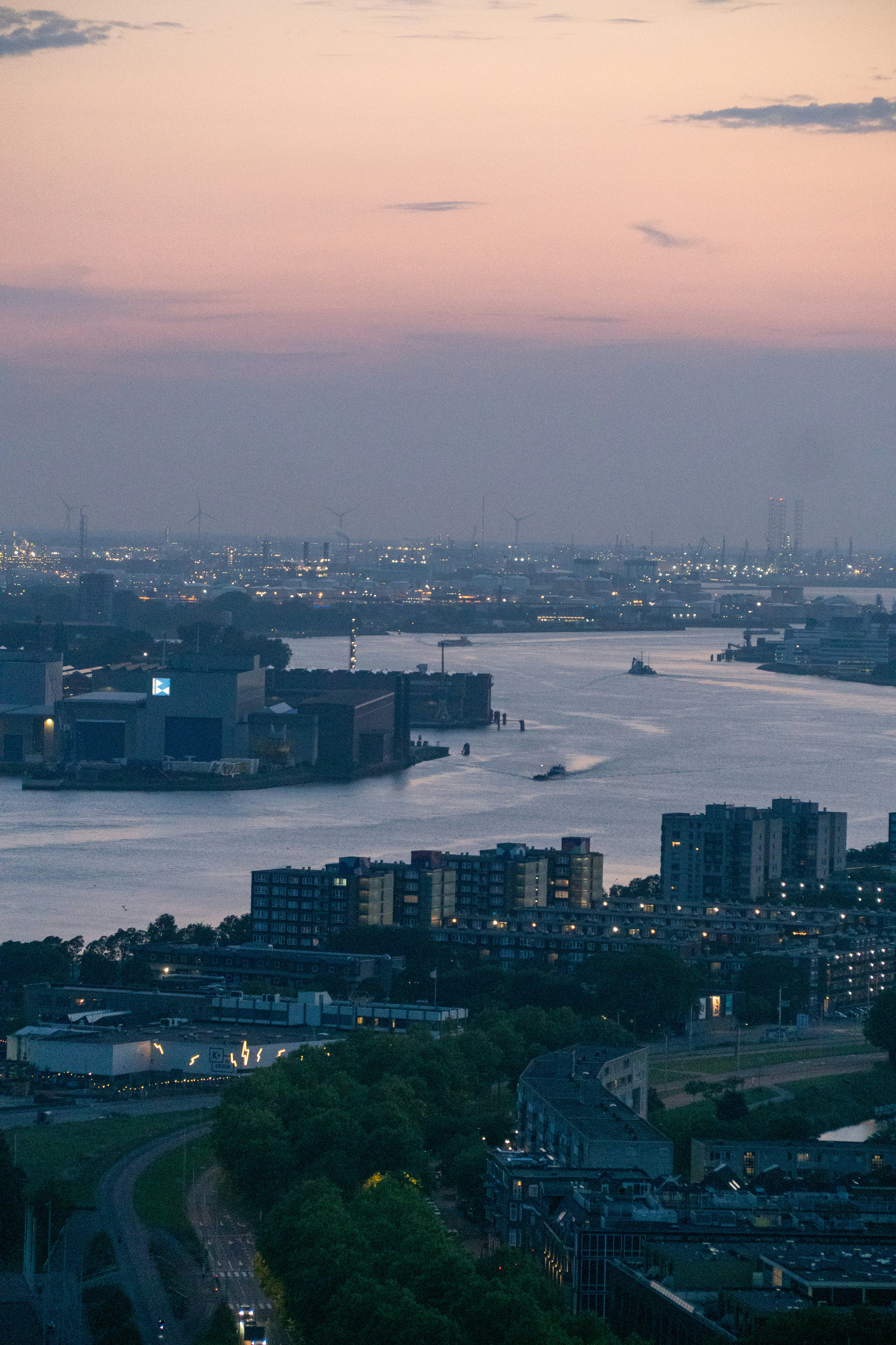Cityscape with river and buildings at dusk.