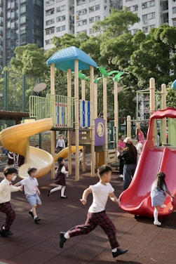 Children playing on a colorful playground with slides