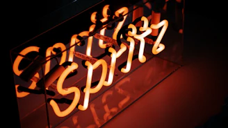 Orange neon sign spelling out "spritz"