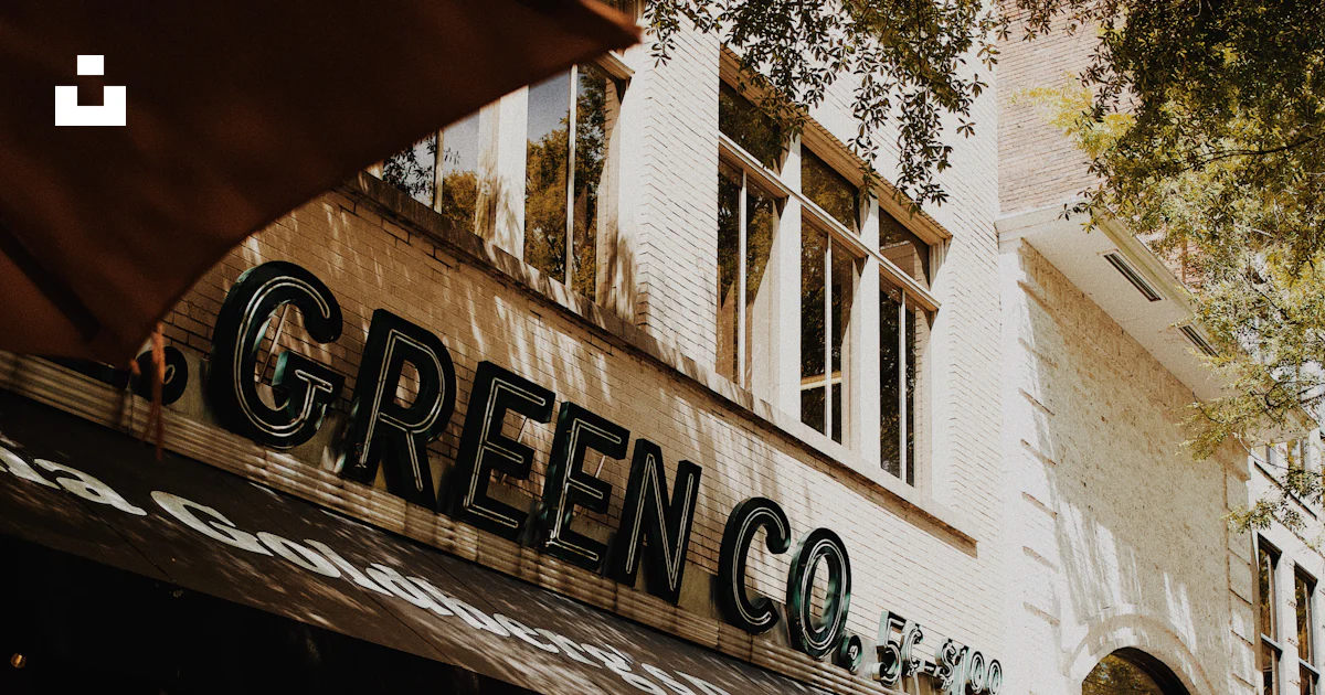 Green co. storefront with outdoor seating and awning. photo – Free Car ...