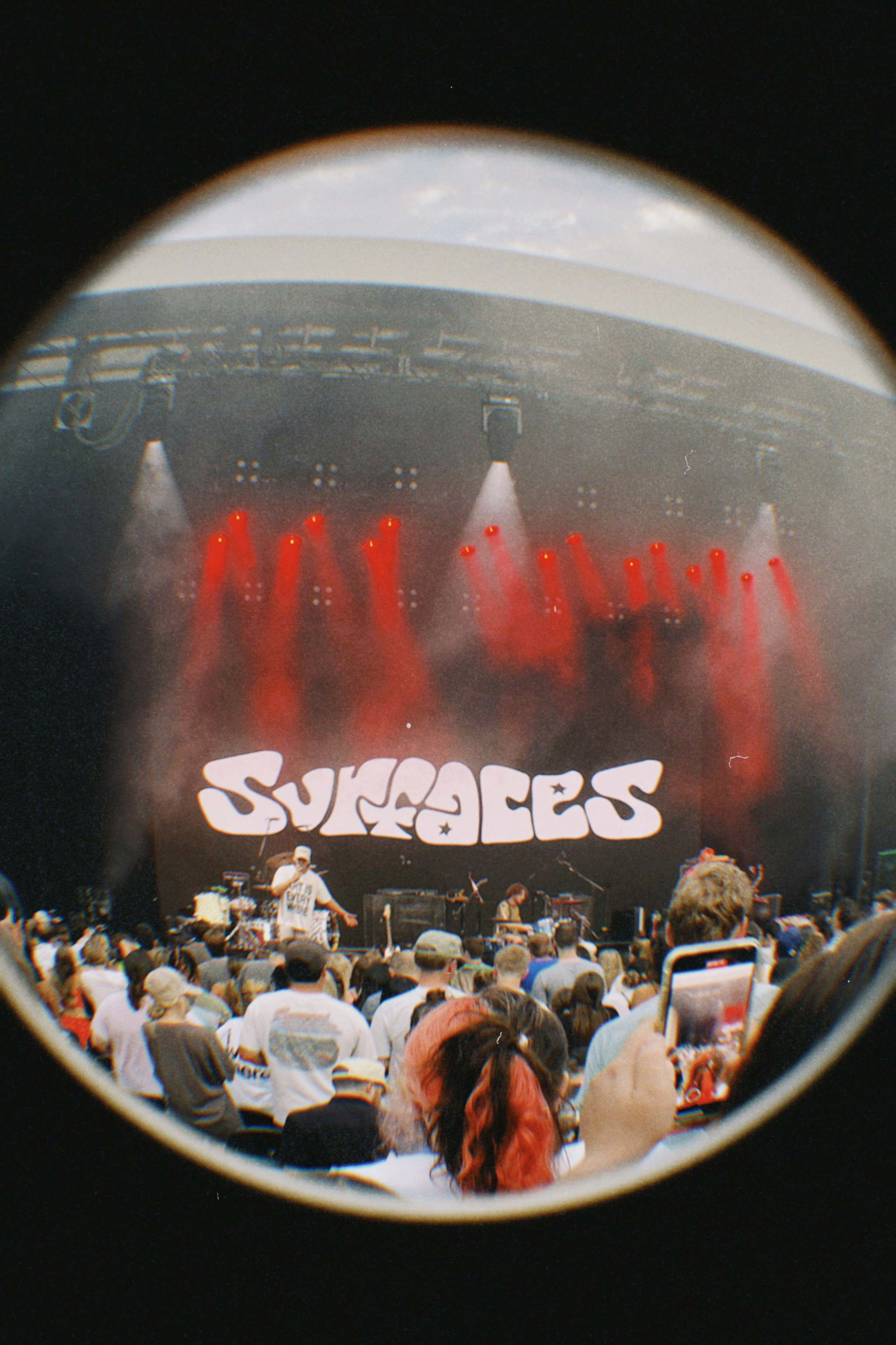 Band performs on stage with crowd watching