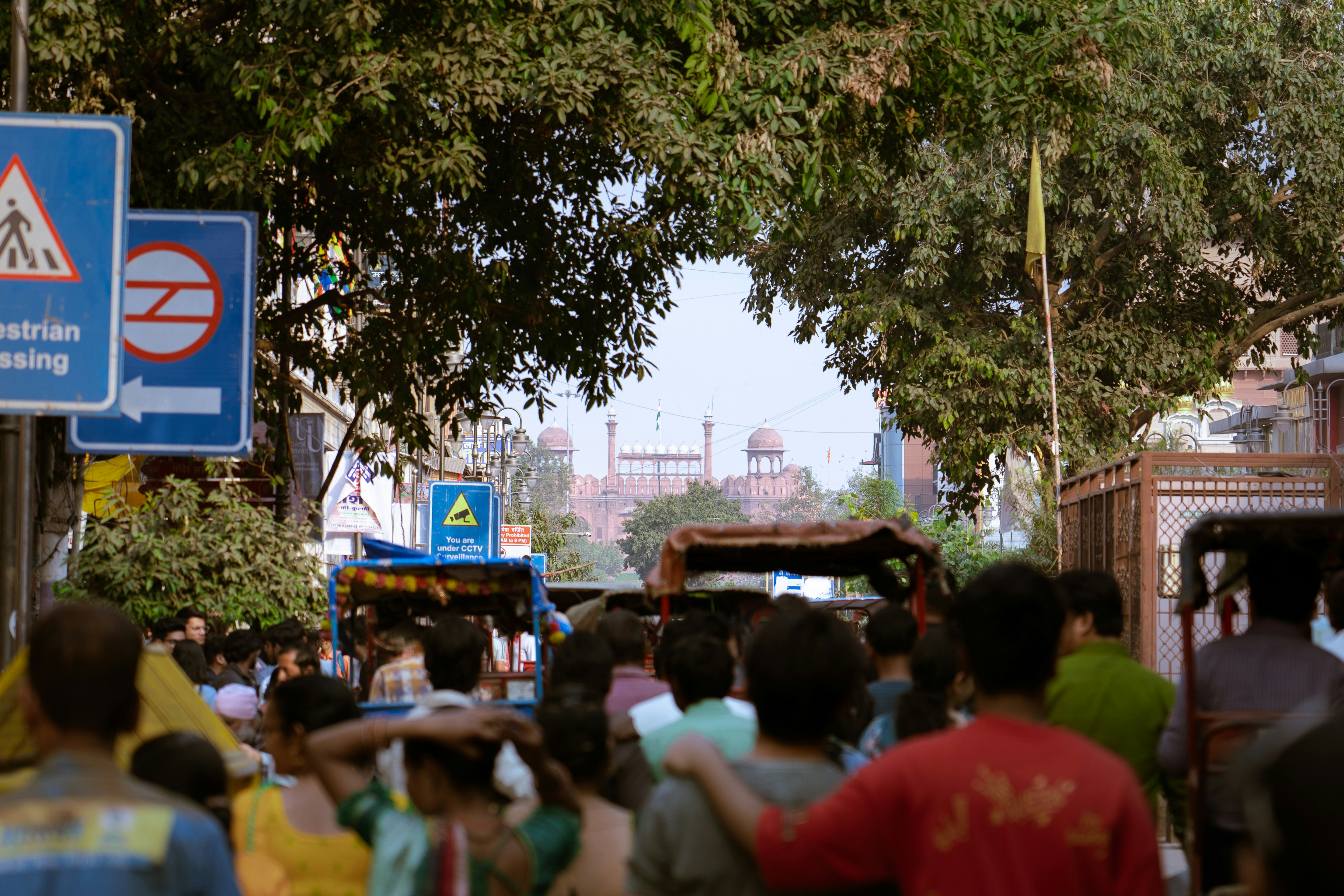 Crowded street with buildings and trees in background