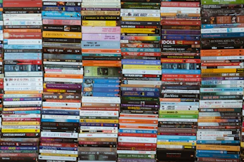 Many colorful books stacked neatly on shelves