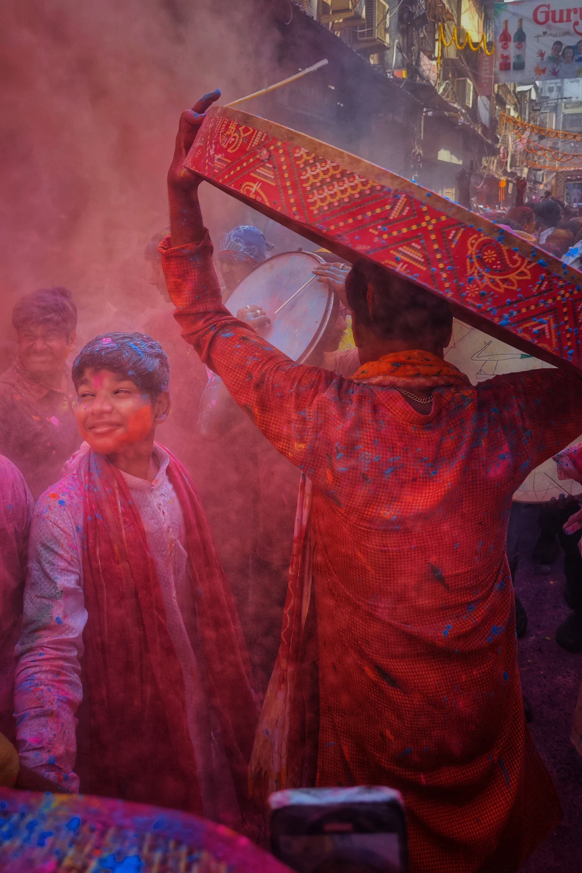 Drums and coloured powder in a joyful Holi street gathering
