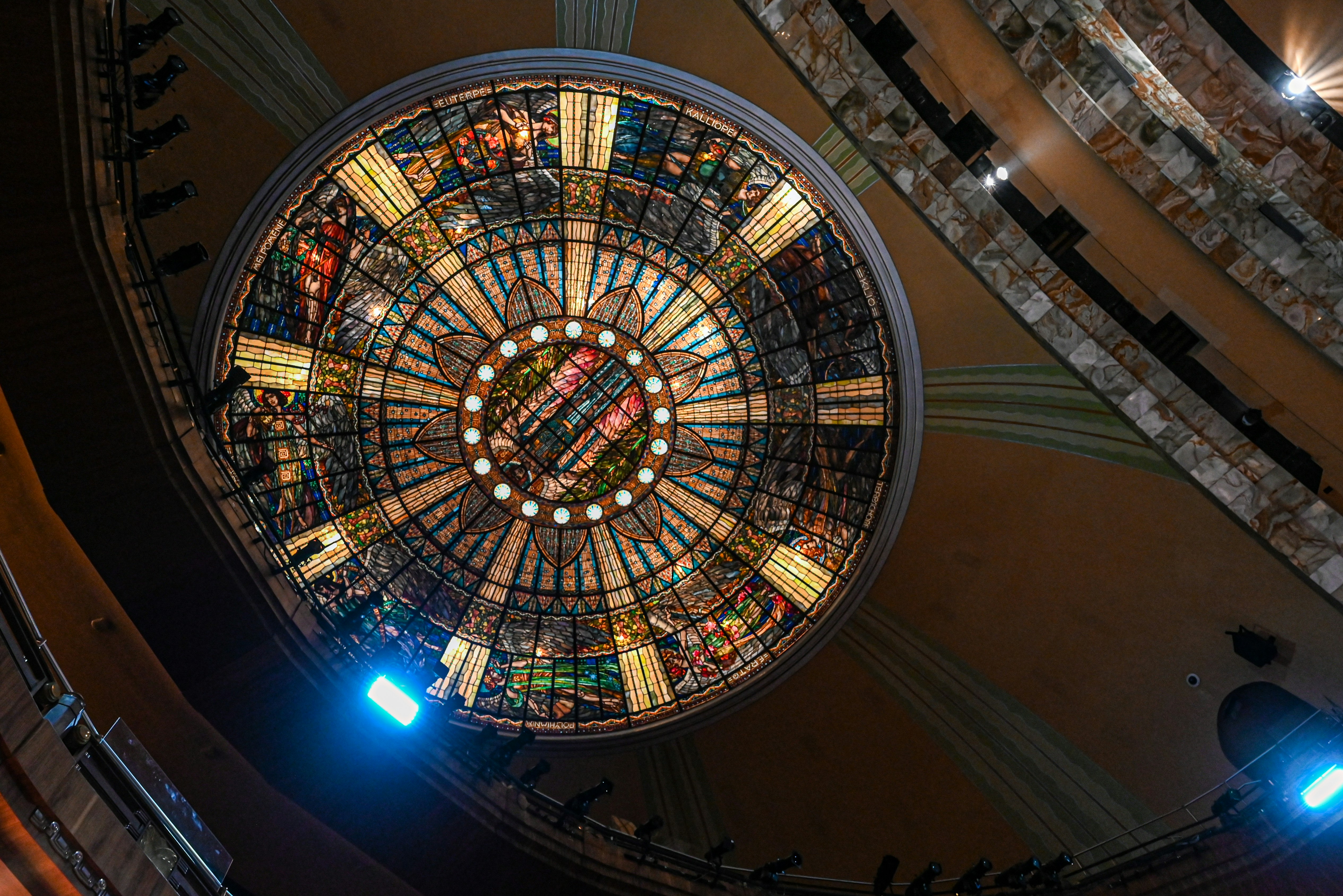 Intricate stained glass dome ceiling illuminated from within.