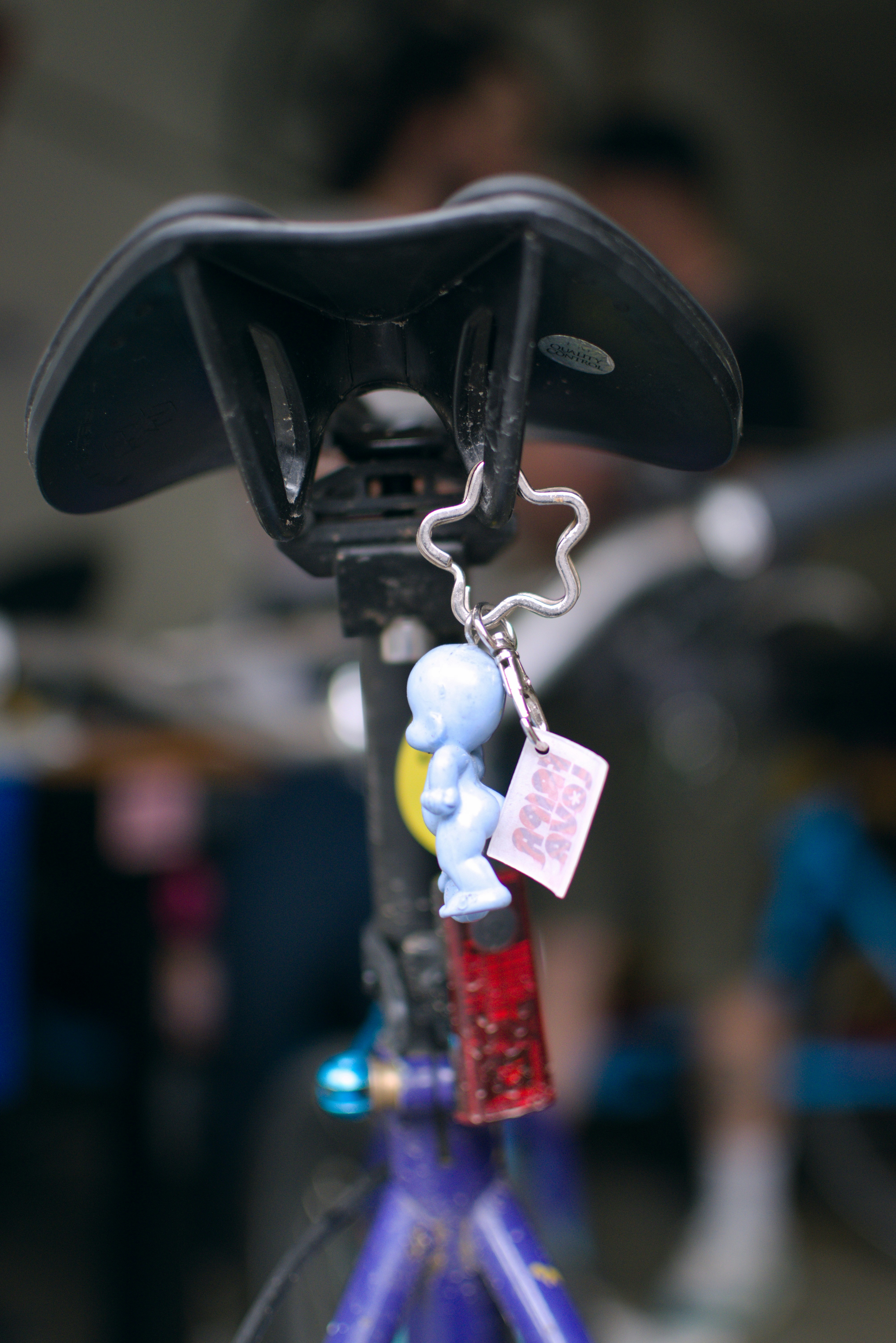 Blue cartoon figure keychain on bicycle seat post
