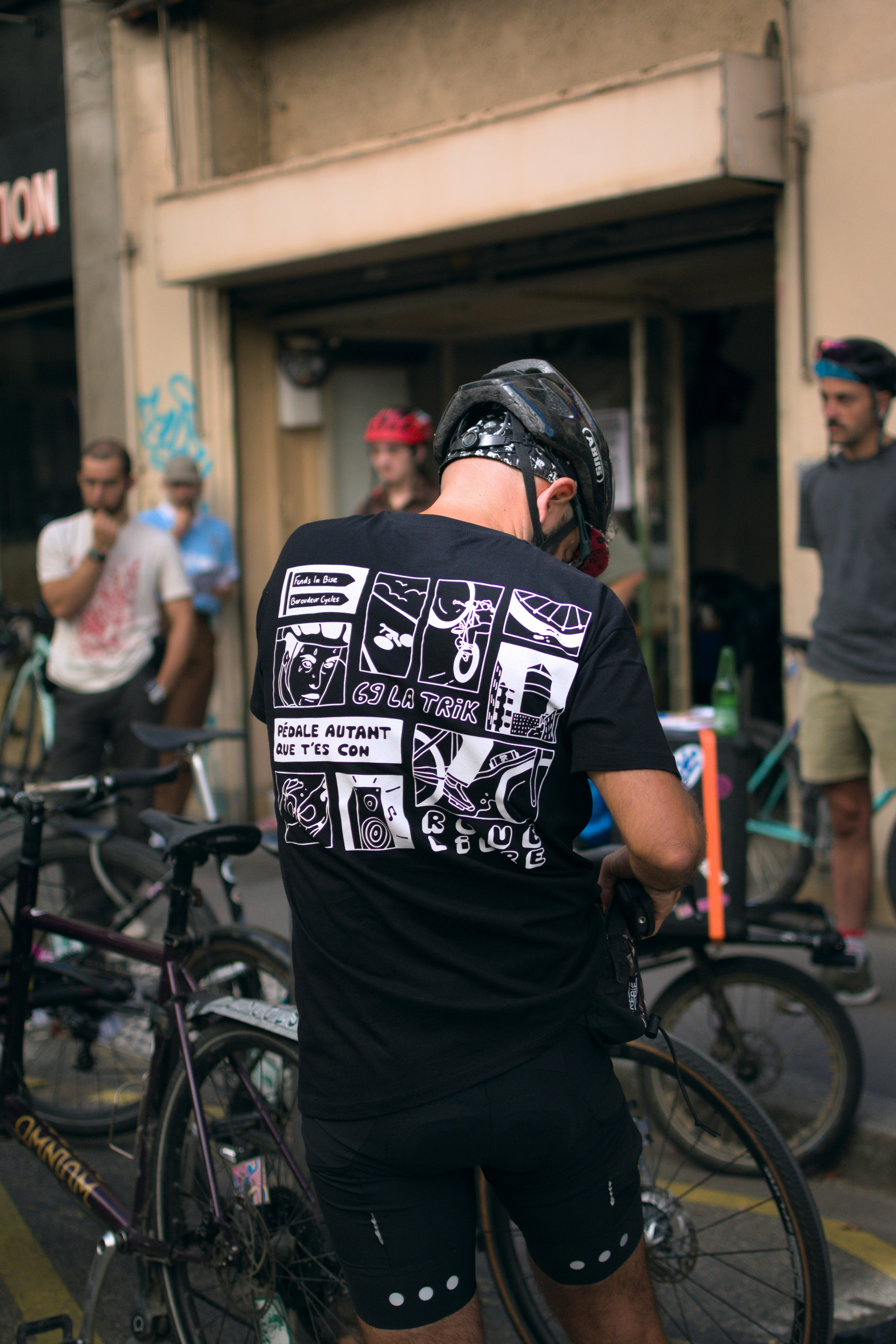 Man in helmet with graphic t-shirt and bicycles