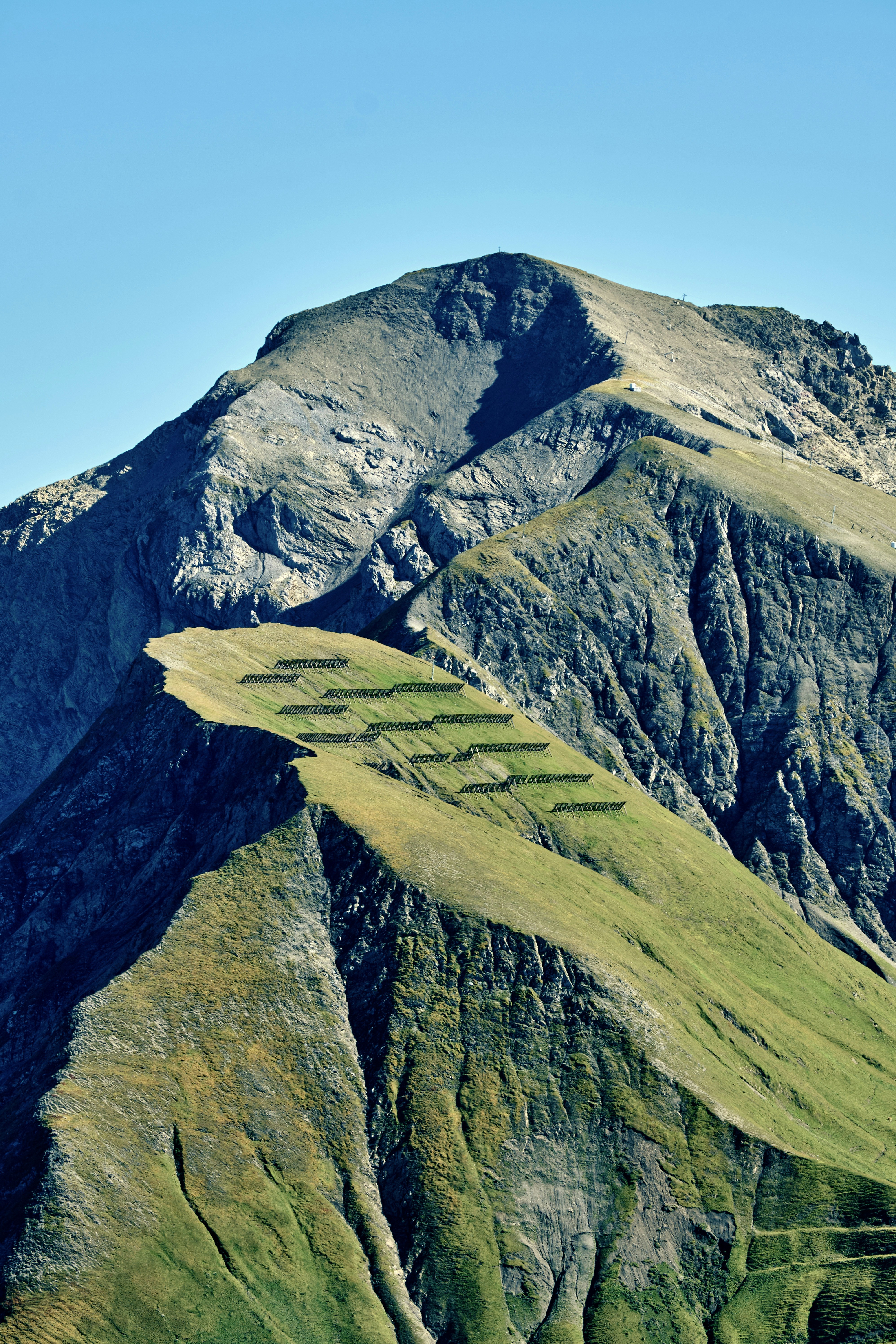 Grassy mountain slopes under a clear blue sky