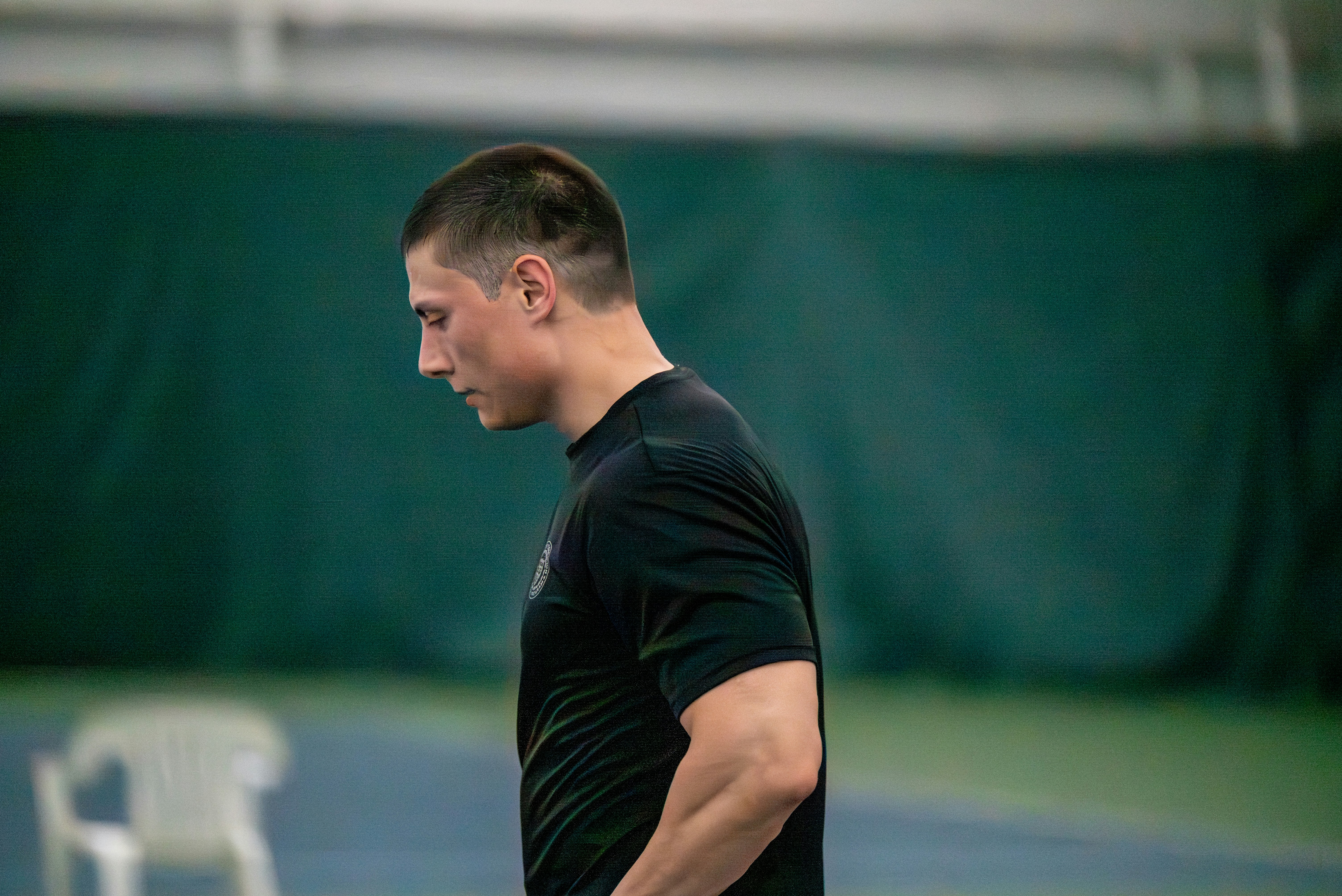 Man in black t-shirt looking down