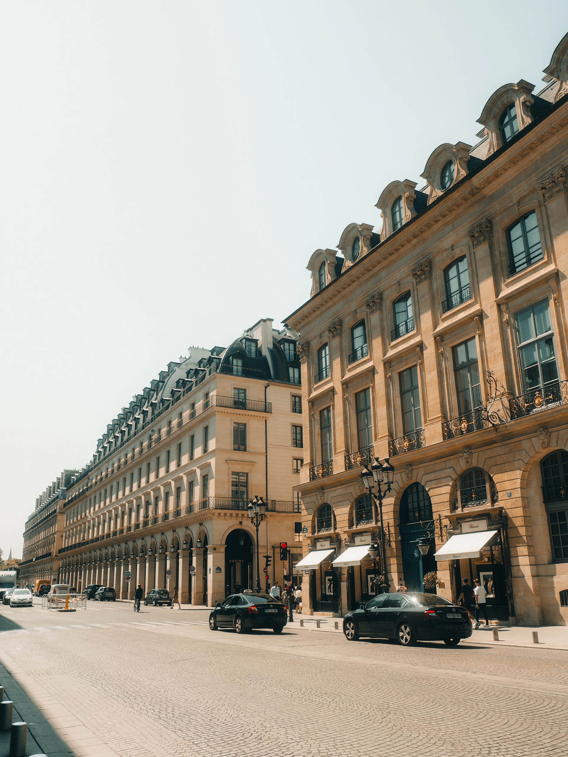 Elegant parisian buildings line a wide street.