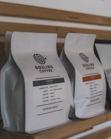 Two bags of gosling coffee on a shelf.