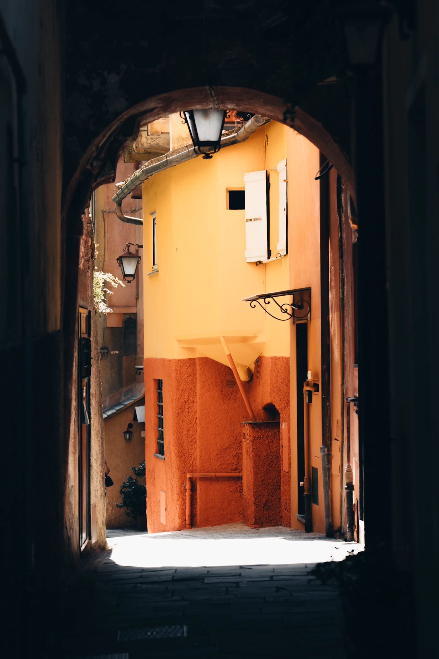 Sunlit narrow Italian street with warm coloured houses, Portofino