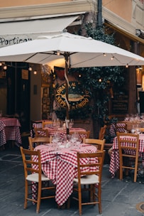 Outdoor restaurant tables with red checkered cloths