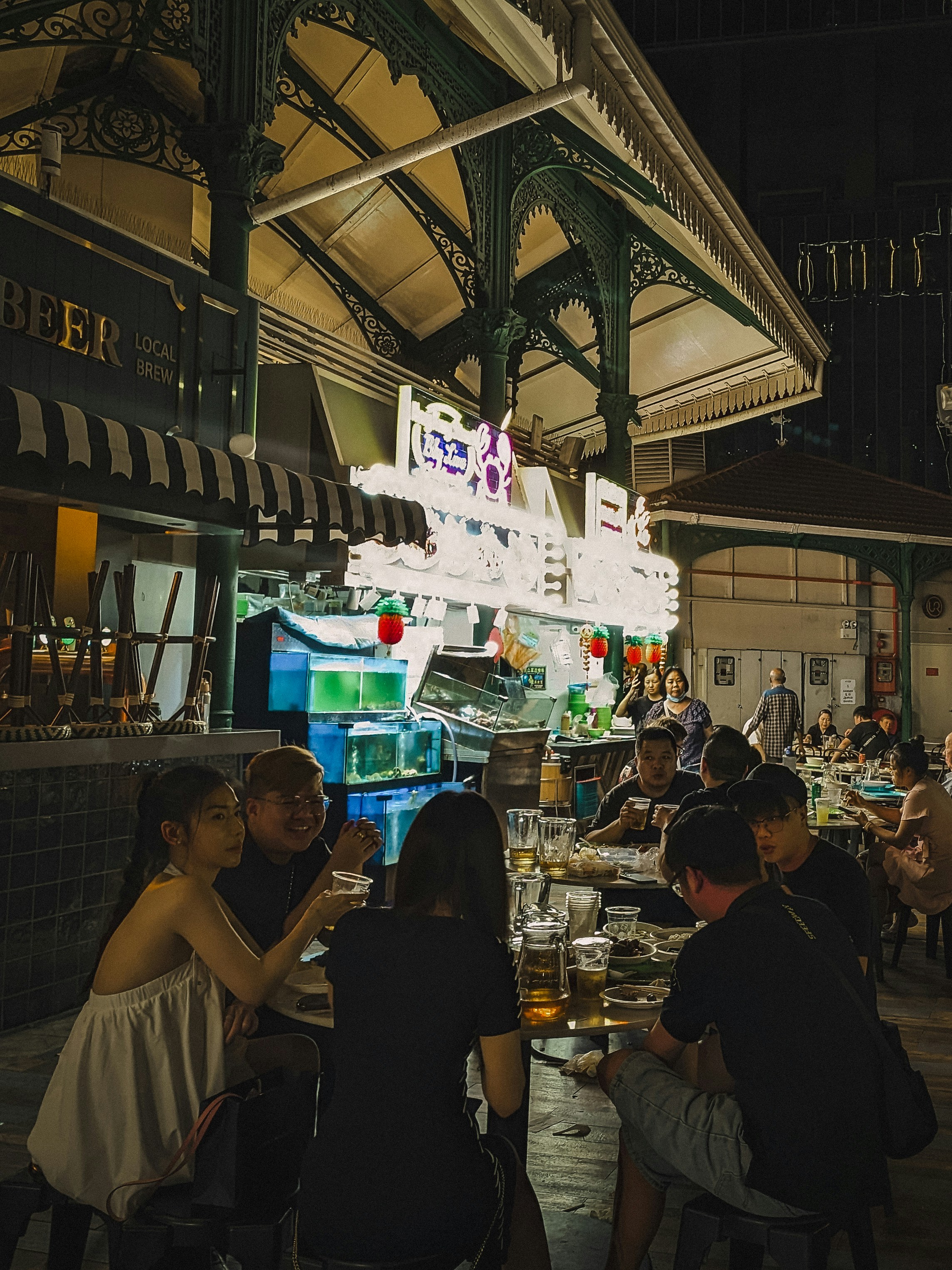 People dining outdoors at a bustling night market.
