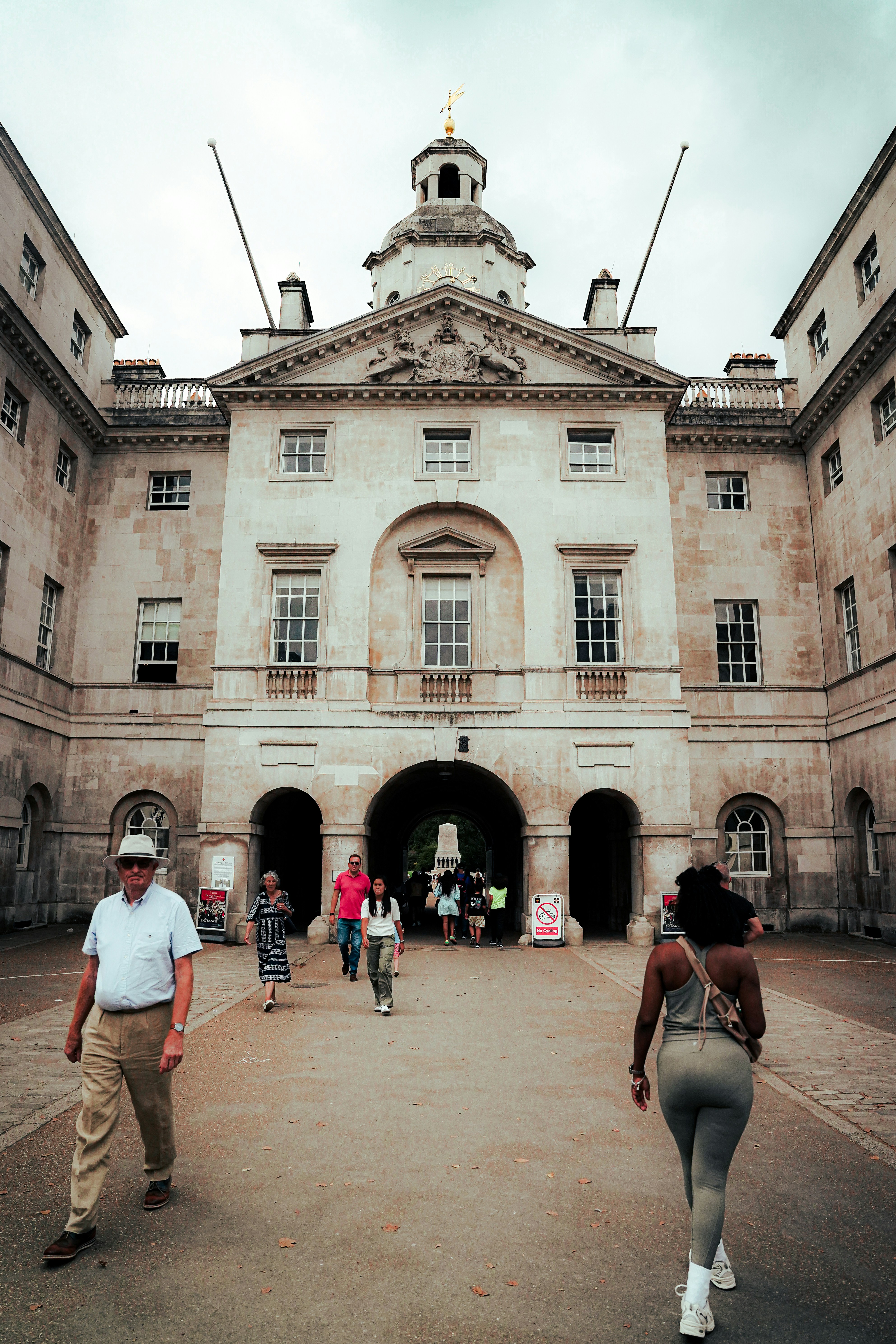 People walking towards a grand stone building entrance