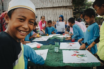 Children happily painting together outdoors