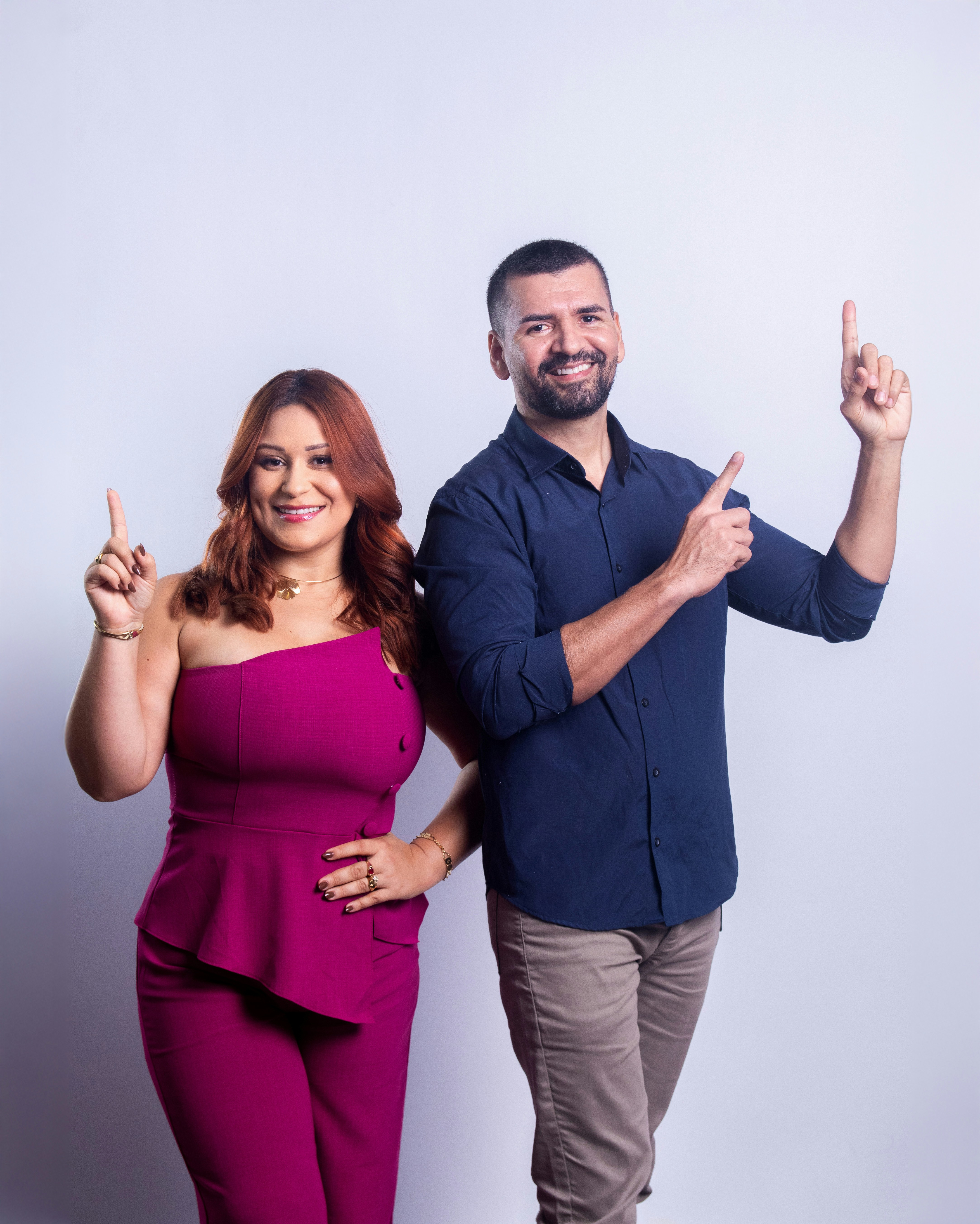 Couple pointing upwards with index fingers