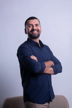 Man in dark blue shirt with arms crossed