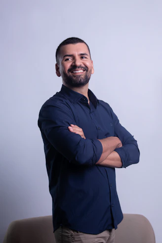 Man in dark blue shirt with arms crossed