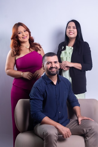 Three people posing for a studio portrait.