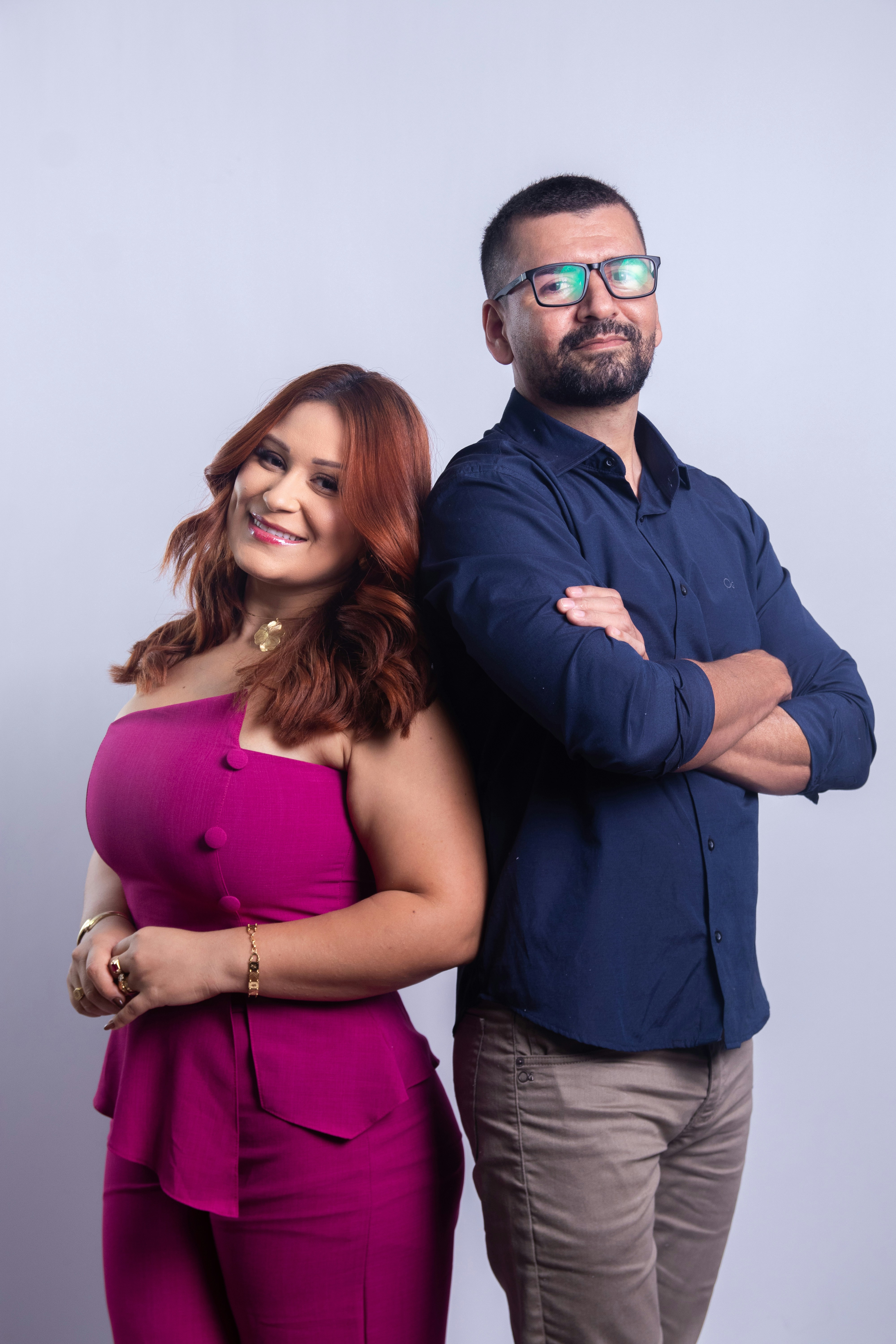A man and woman standing back to back