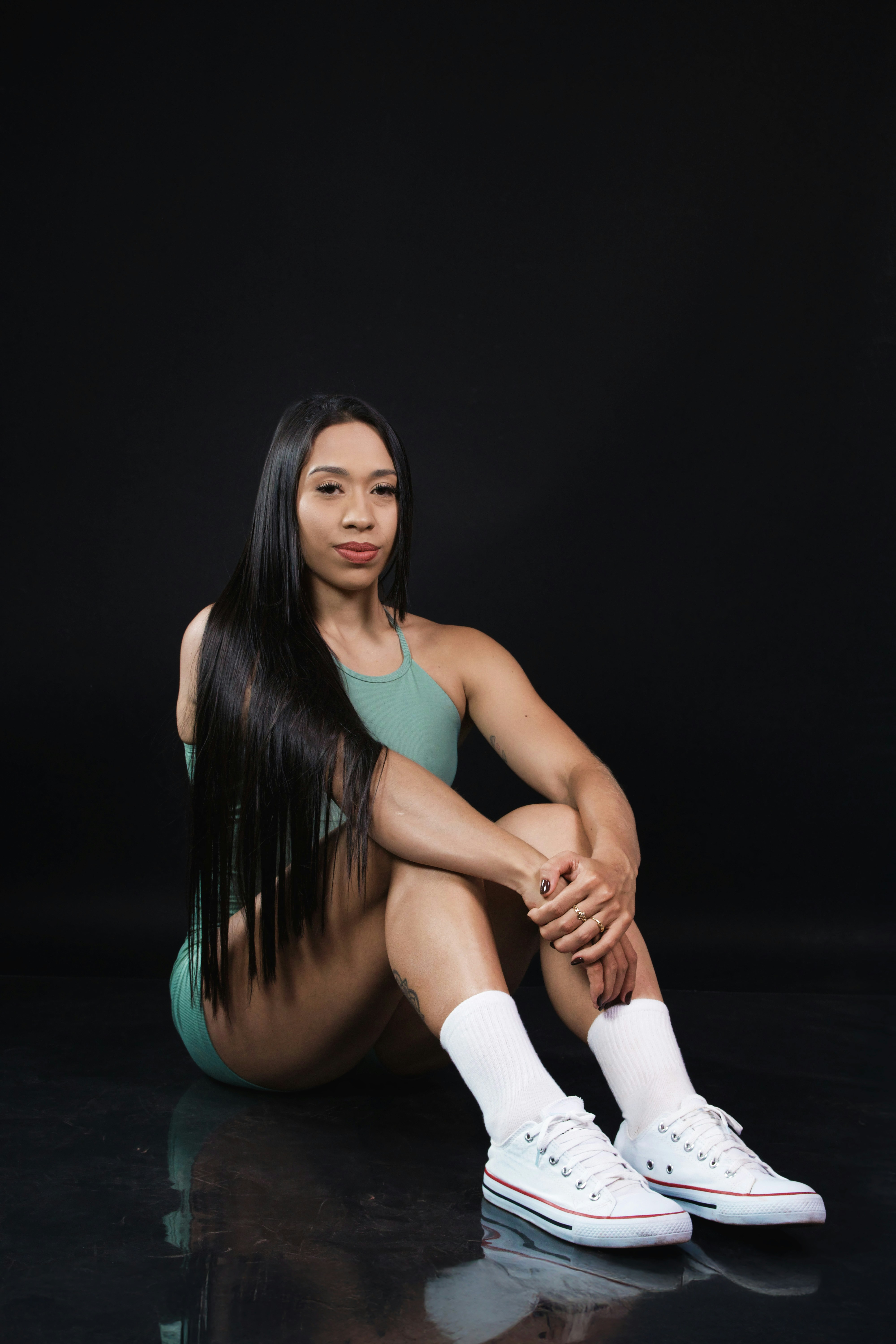 Woman in workout clothes sitting on floor