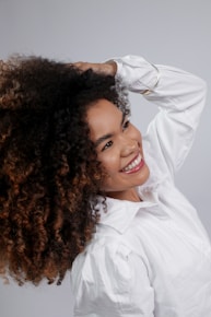 Young woman with curly hair smiling brightly