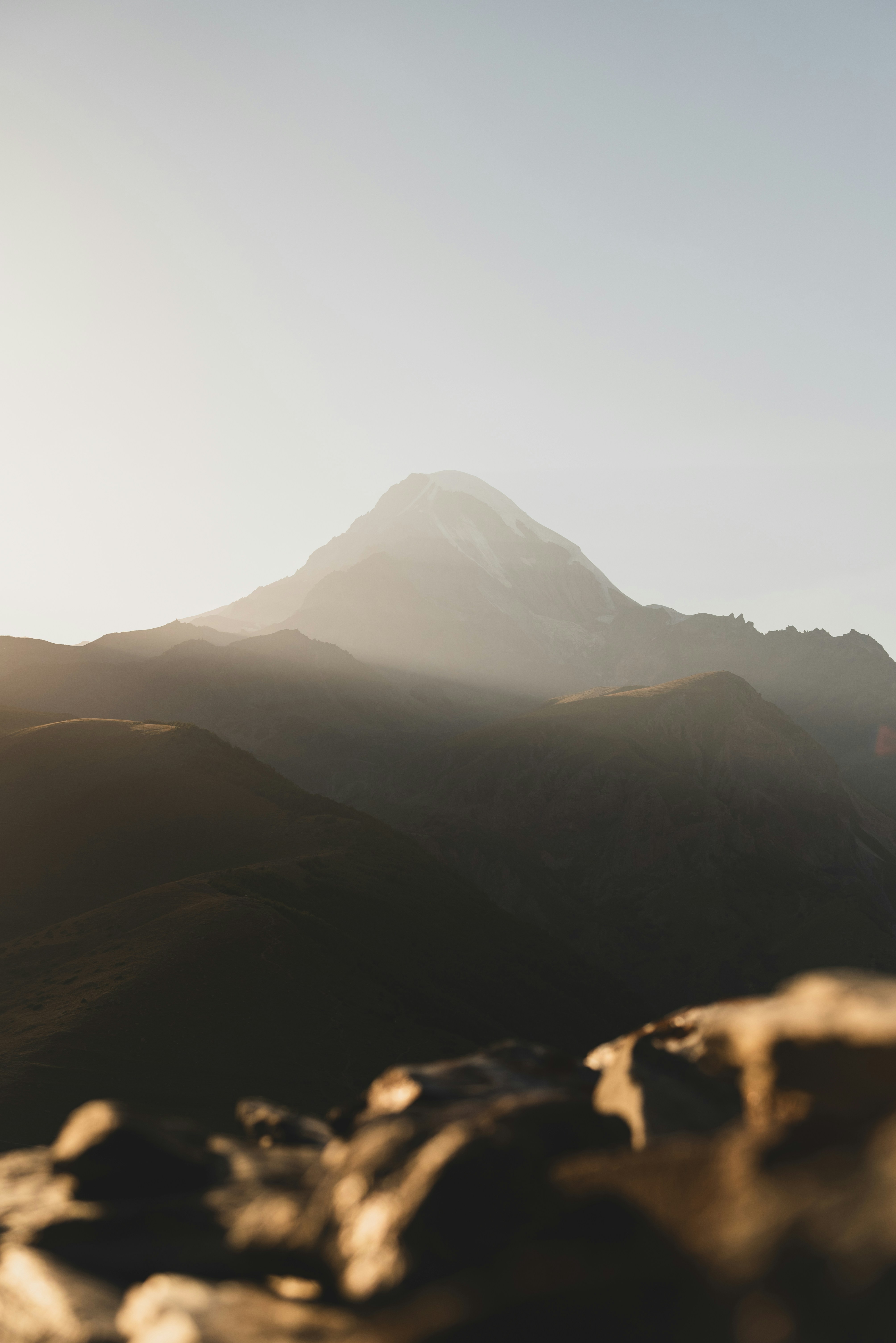 Snow-capped mountain peak bathed in soft light