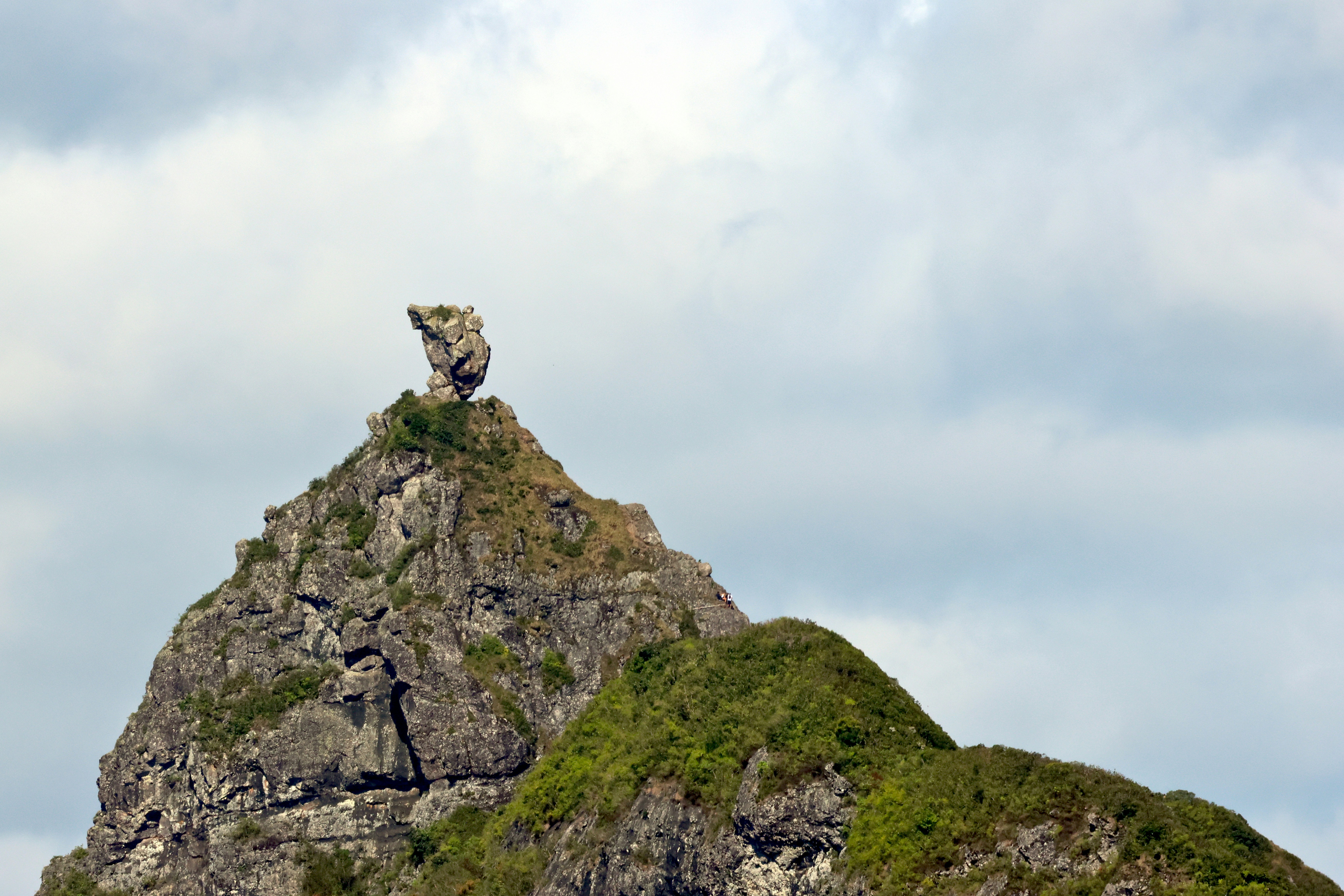 A person climbing a mountain, symbolizing perseverance