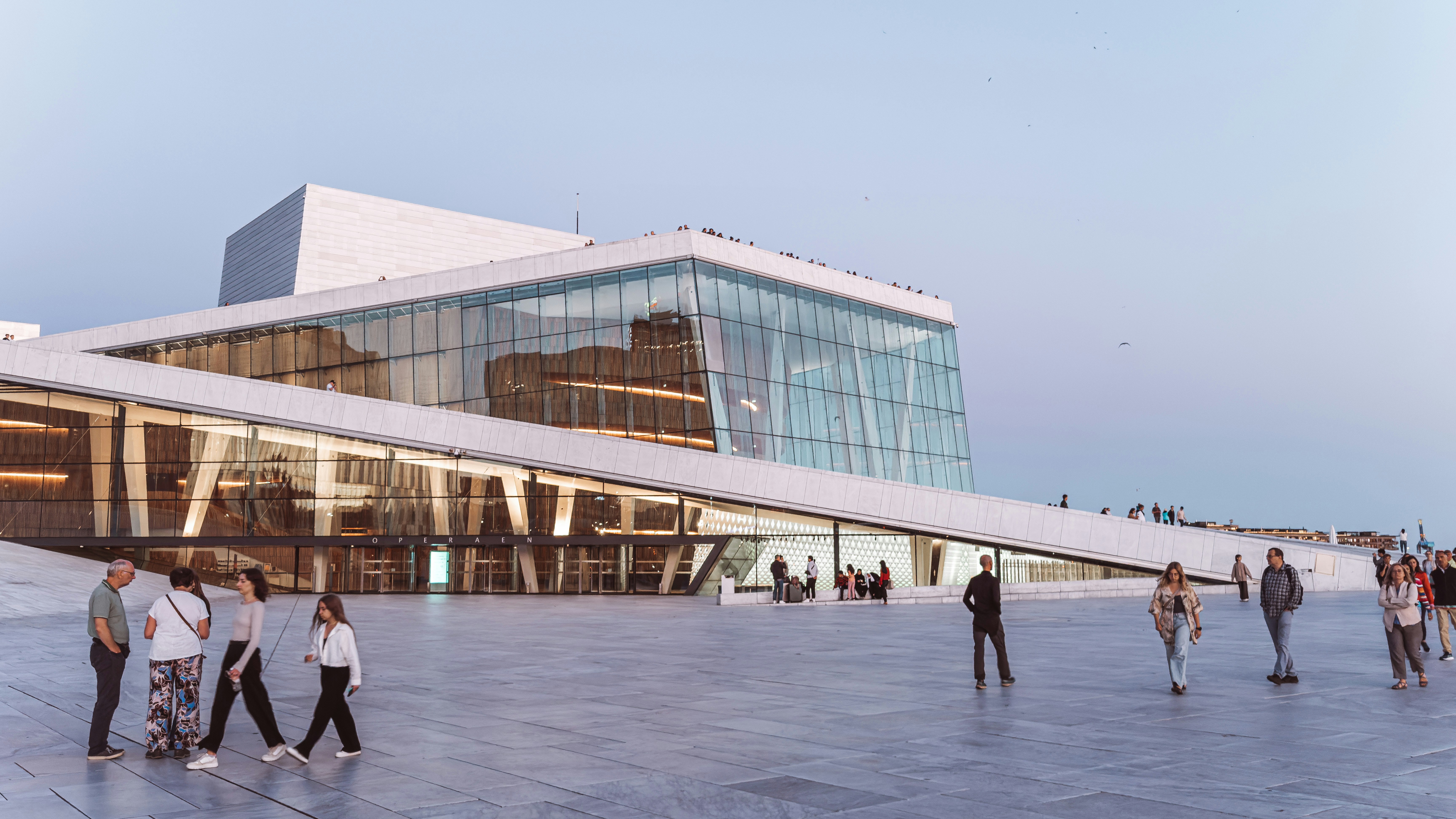 Modern building with glass facade and people walking