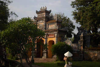 Traditional vietnamese gate with a person wearing a conical hat.
