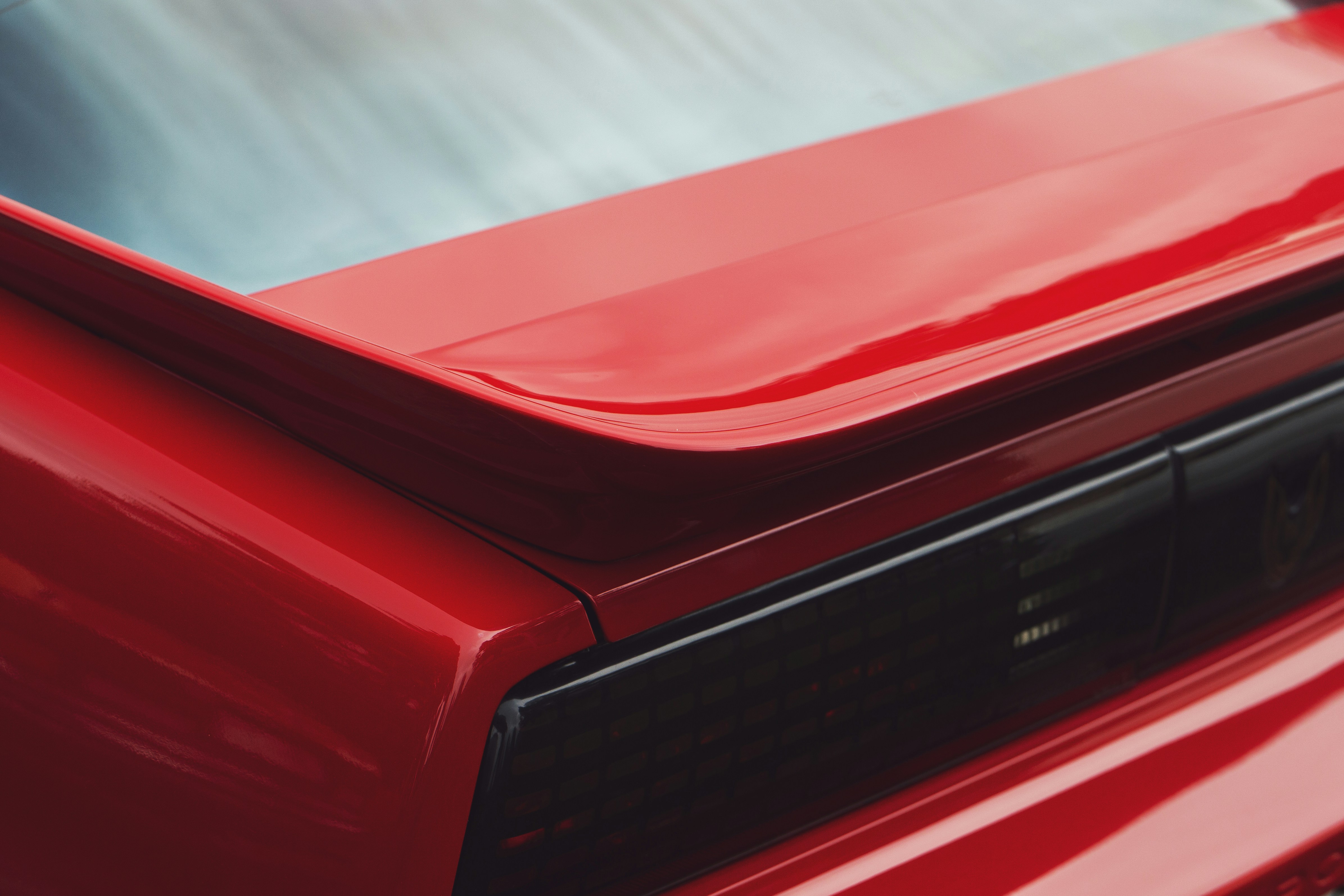 Close-up of a shiny red car spoiler
