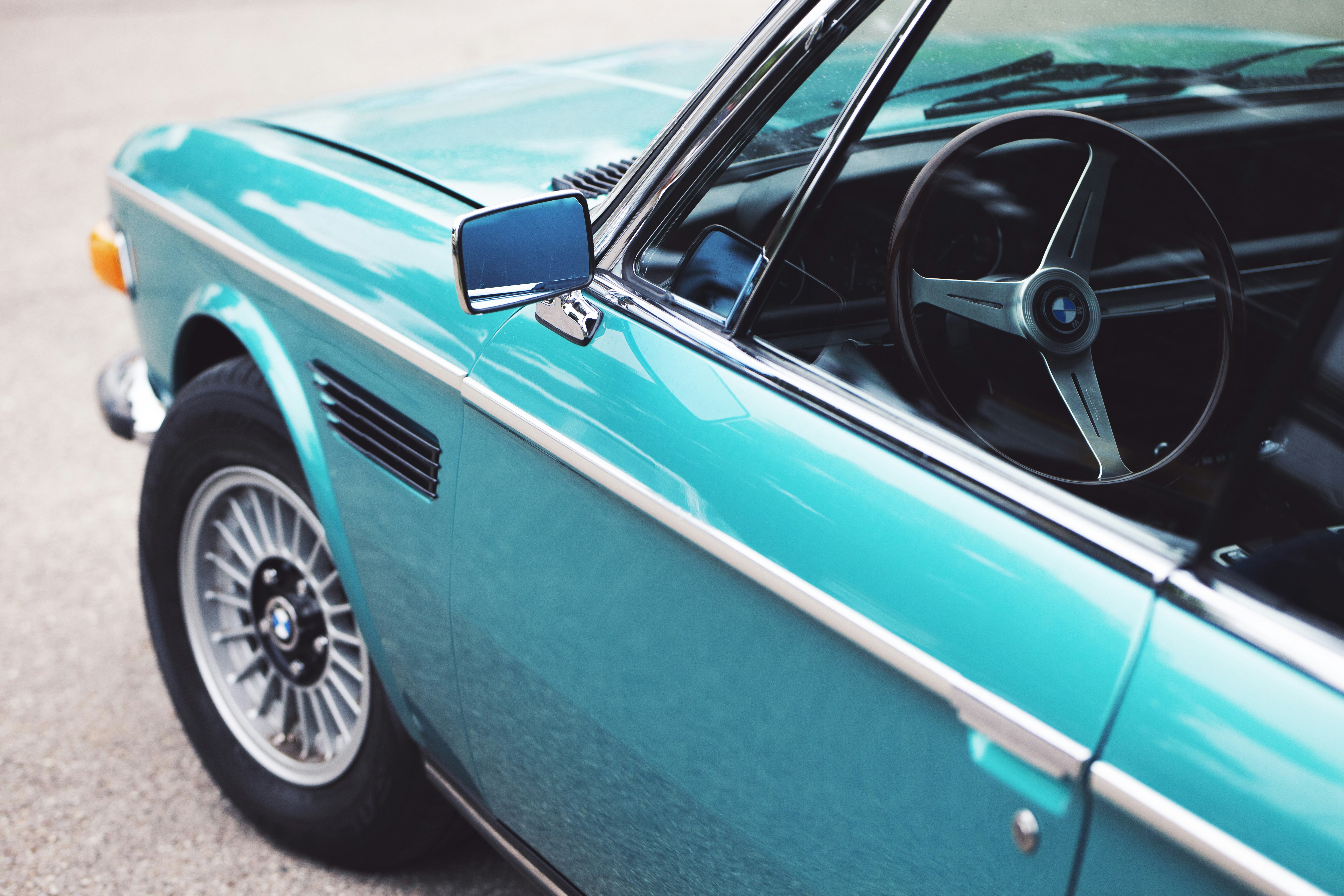 Turquoise vintage convertible car interior and steering wheel