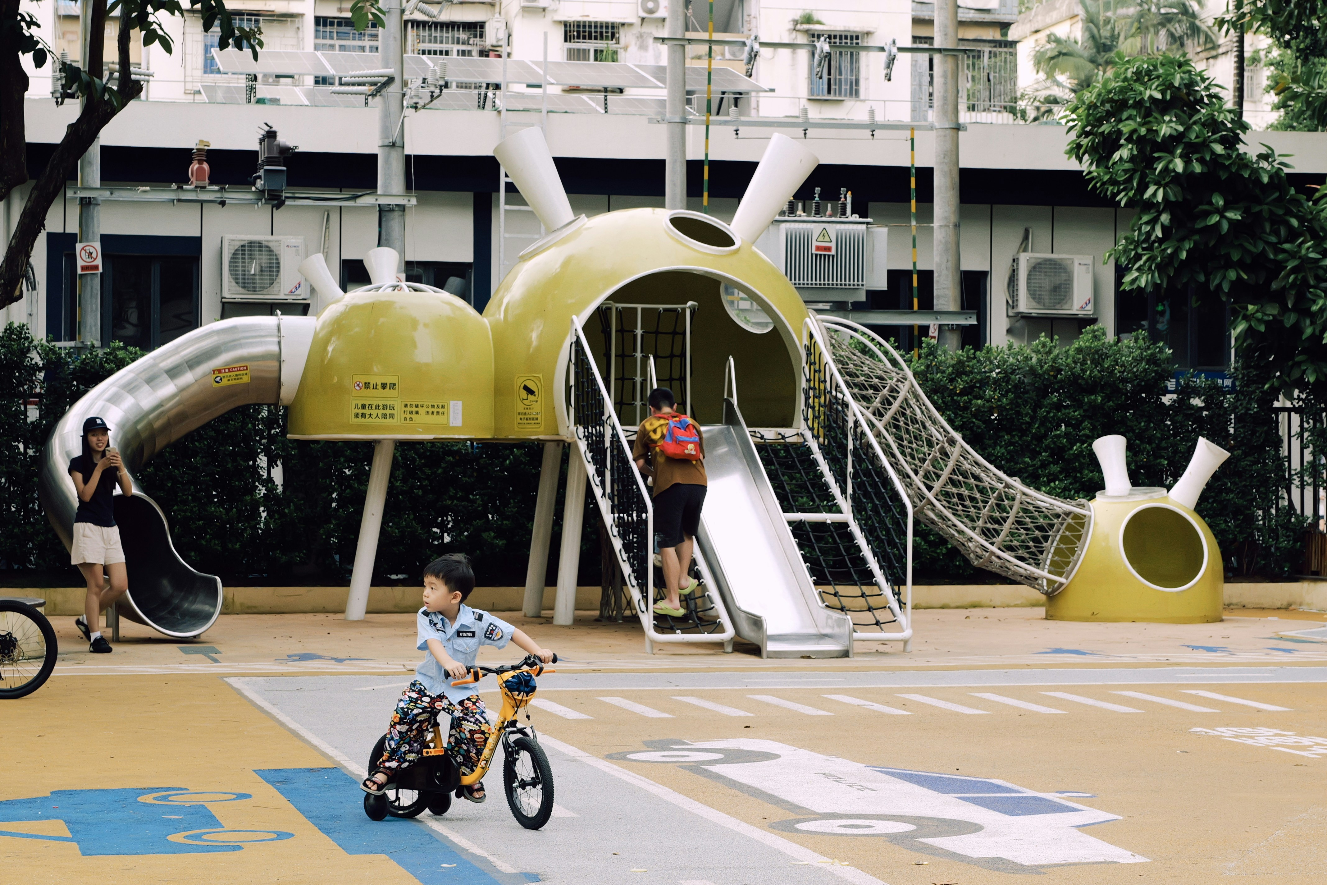 Children playing on a unique playground structure.