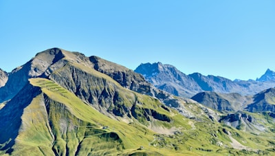 Green mountains under a clear blue sky