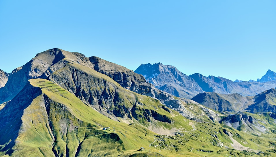 Green mountains under a clear blue sky