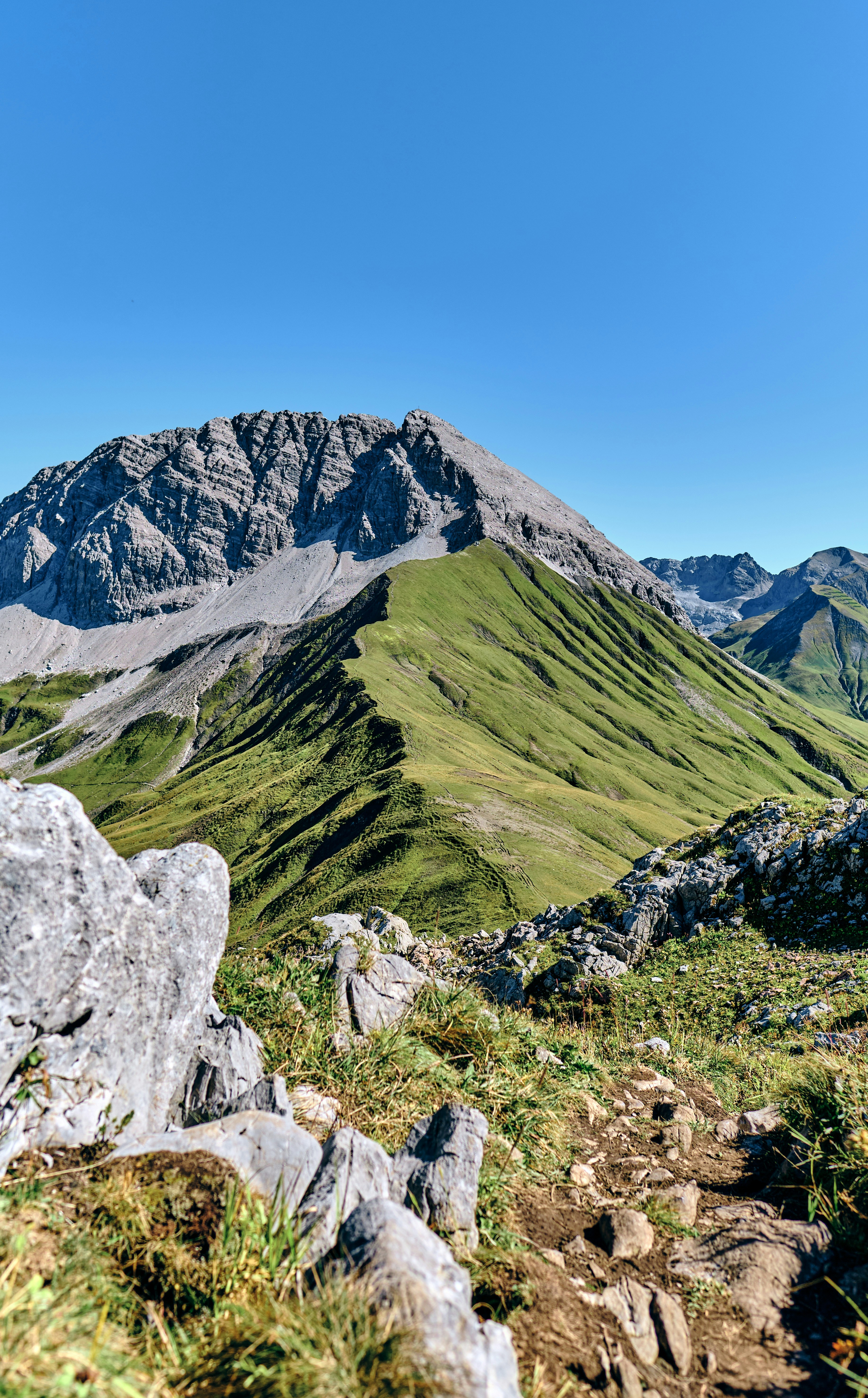 A majestic mountain range under a clear blue sky.