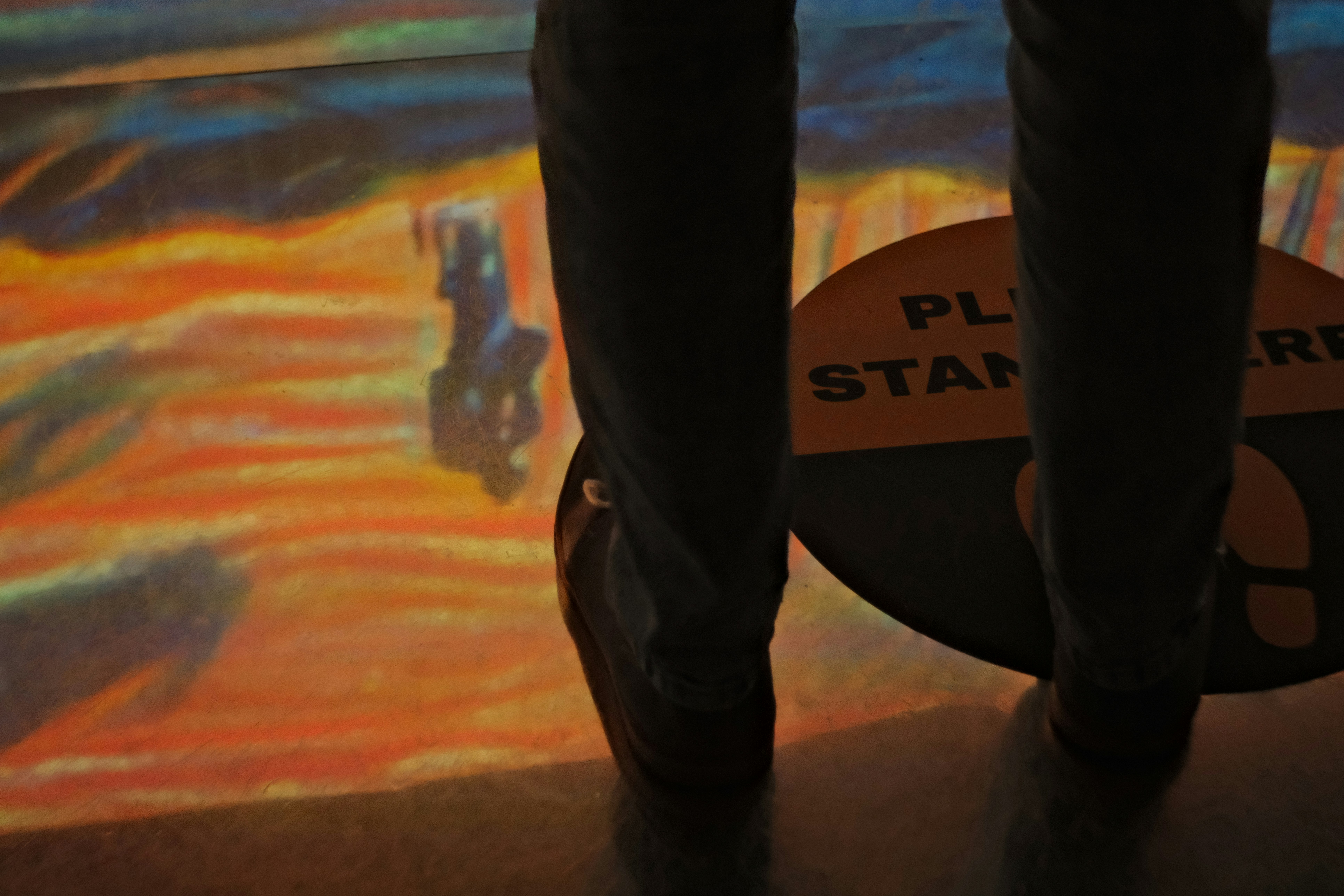 A retro‑futuristic teleportation pad with glowing orange lights and a silhouette of a person stepping through