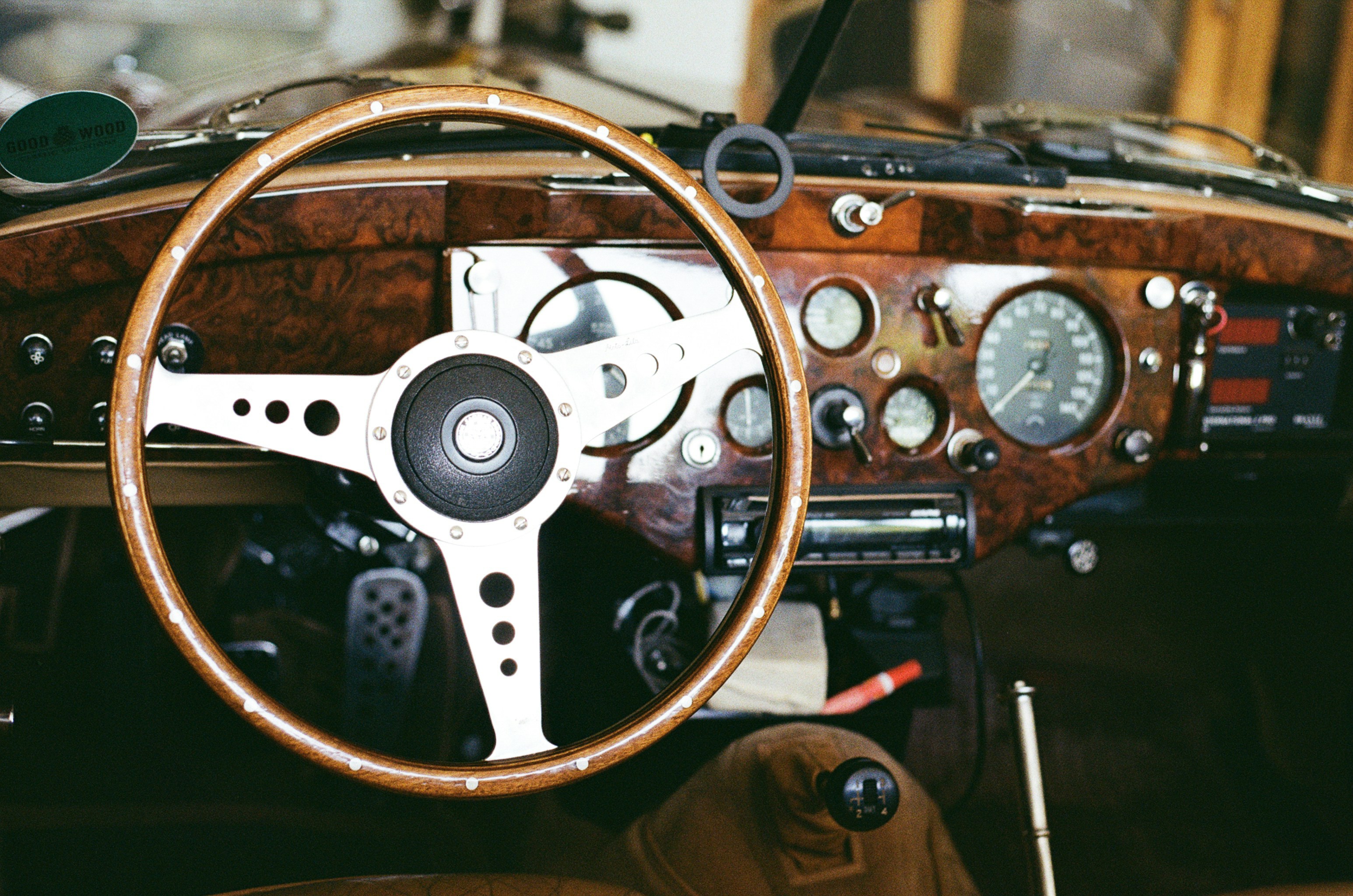 Vintage car dashboard with wooden steering wheel.