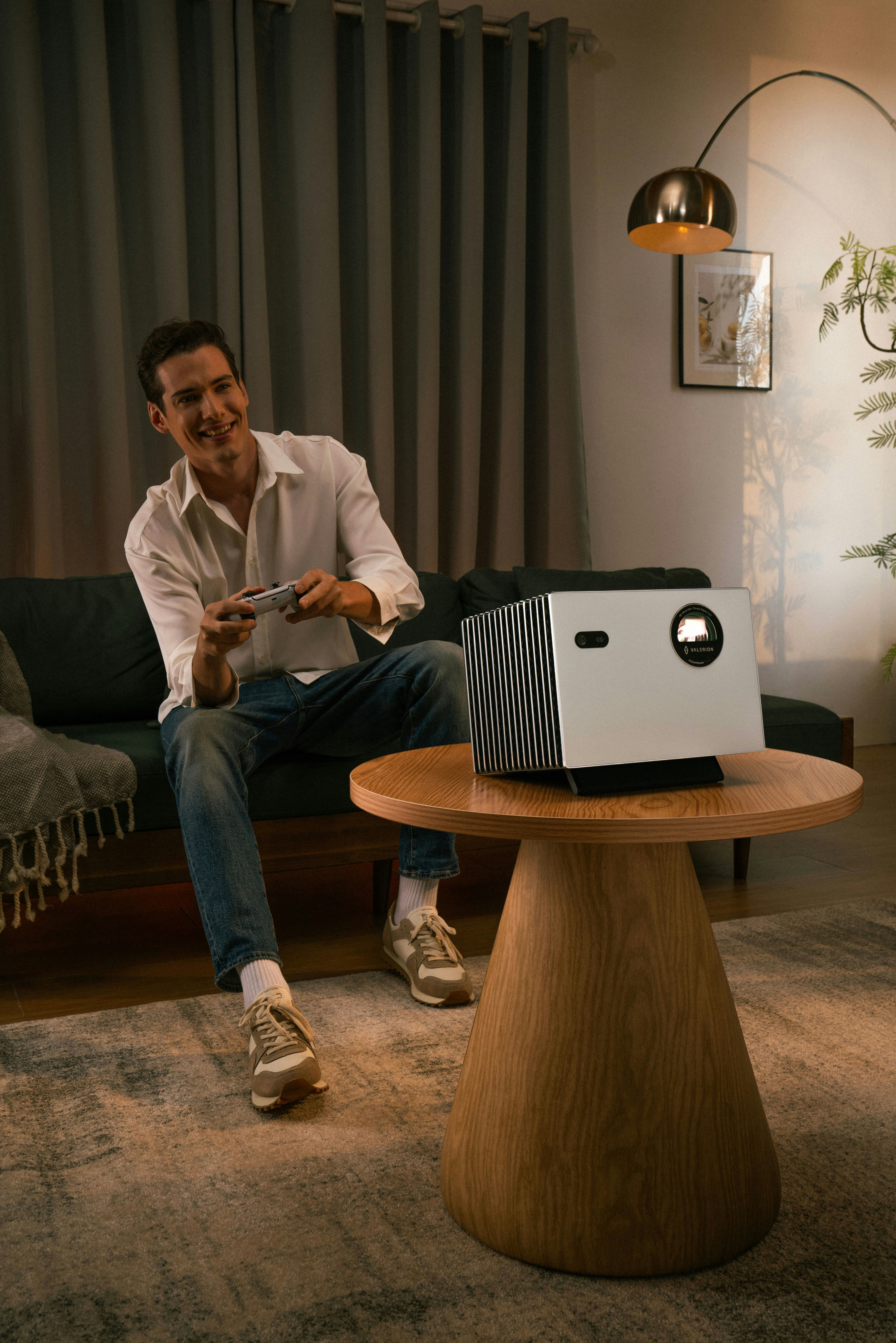 Man playing video games with projector in living room