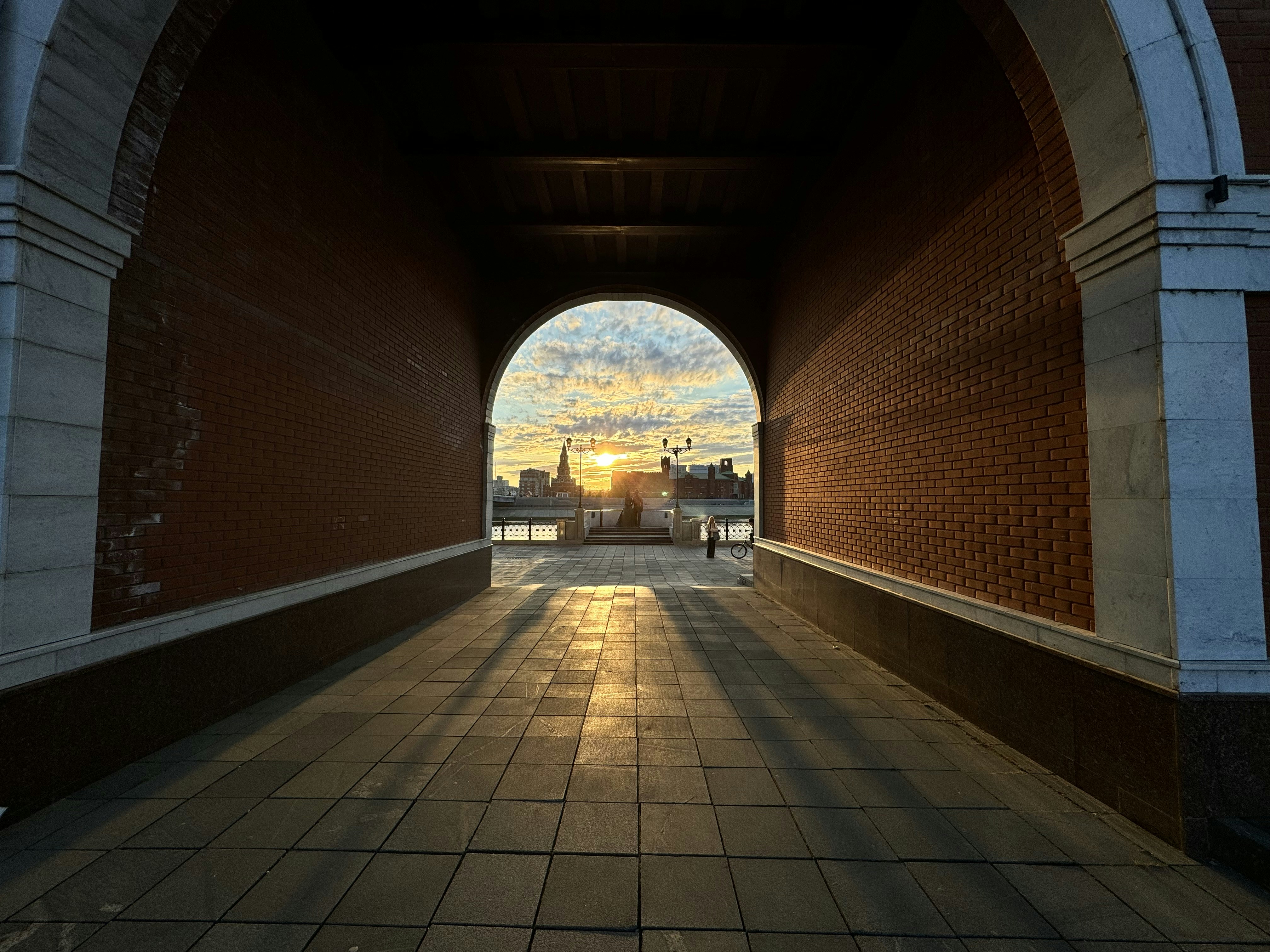 Sunset viewed through an arched passageway