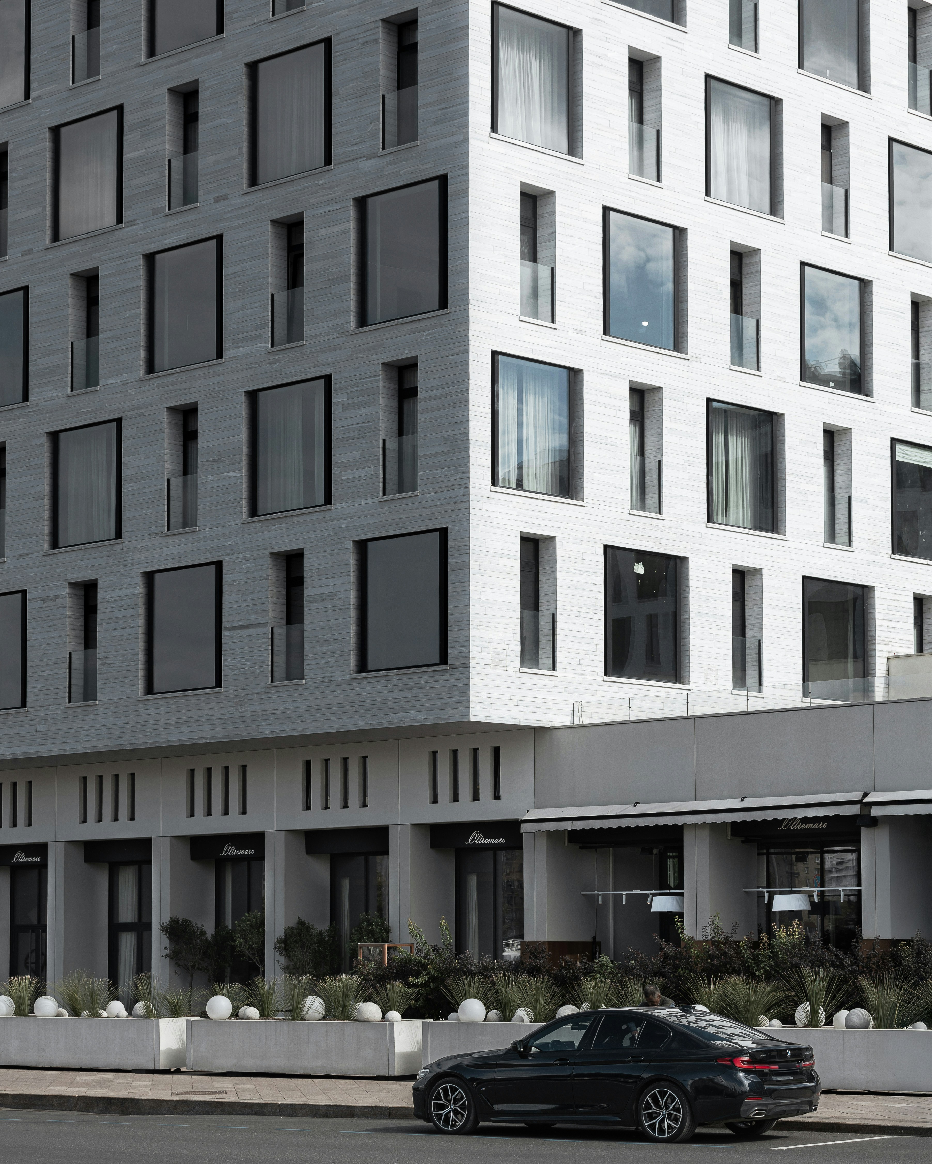 Modern building with a car parked outside.