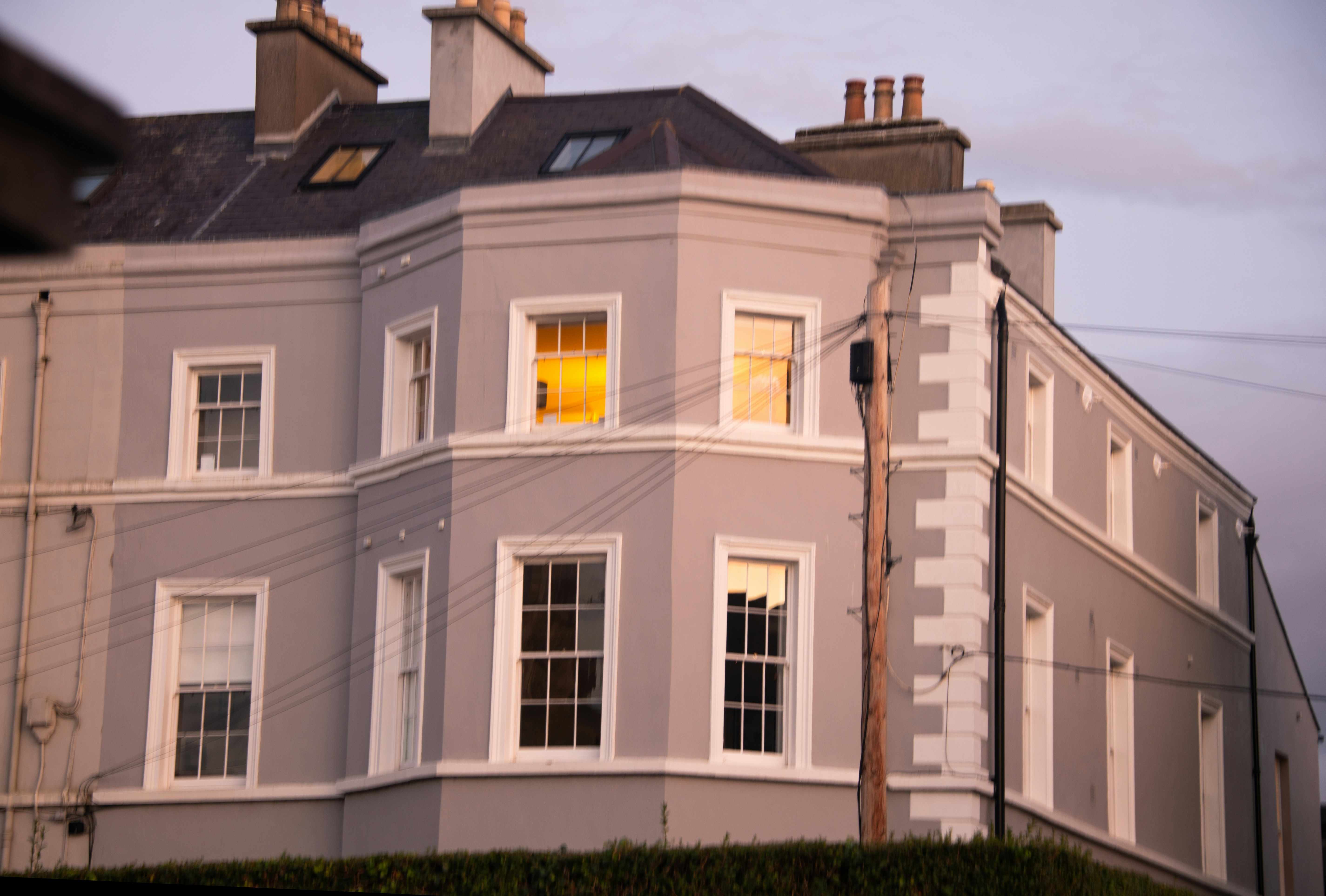 A large gray building with white trim and windows.
