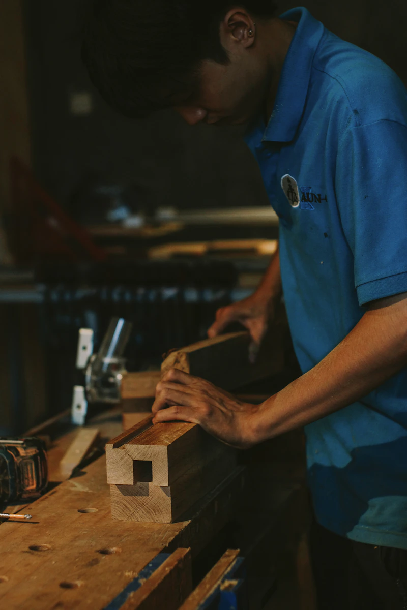 Woodworker using hand tools to cut precise joinery