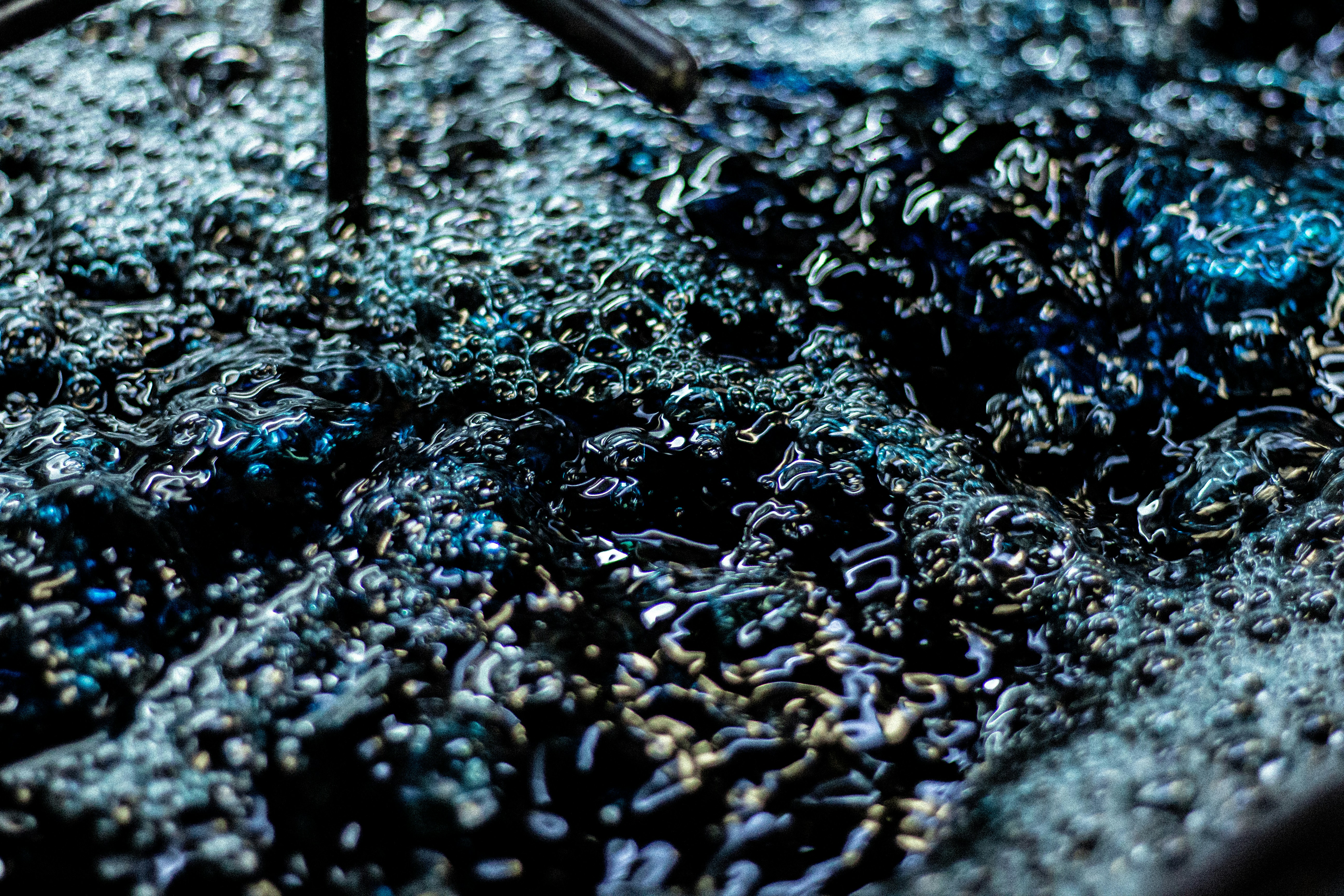 Close-up of dark blue liquid with bubbles.