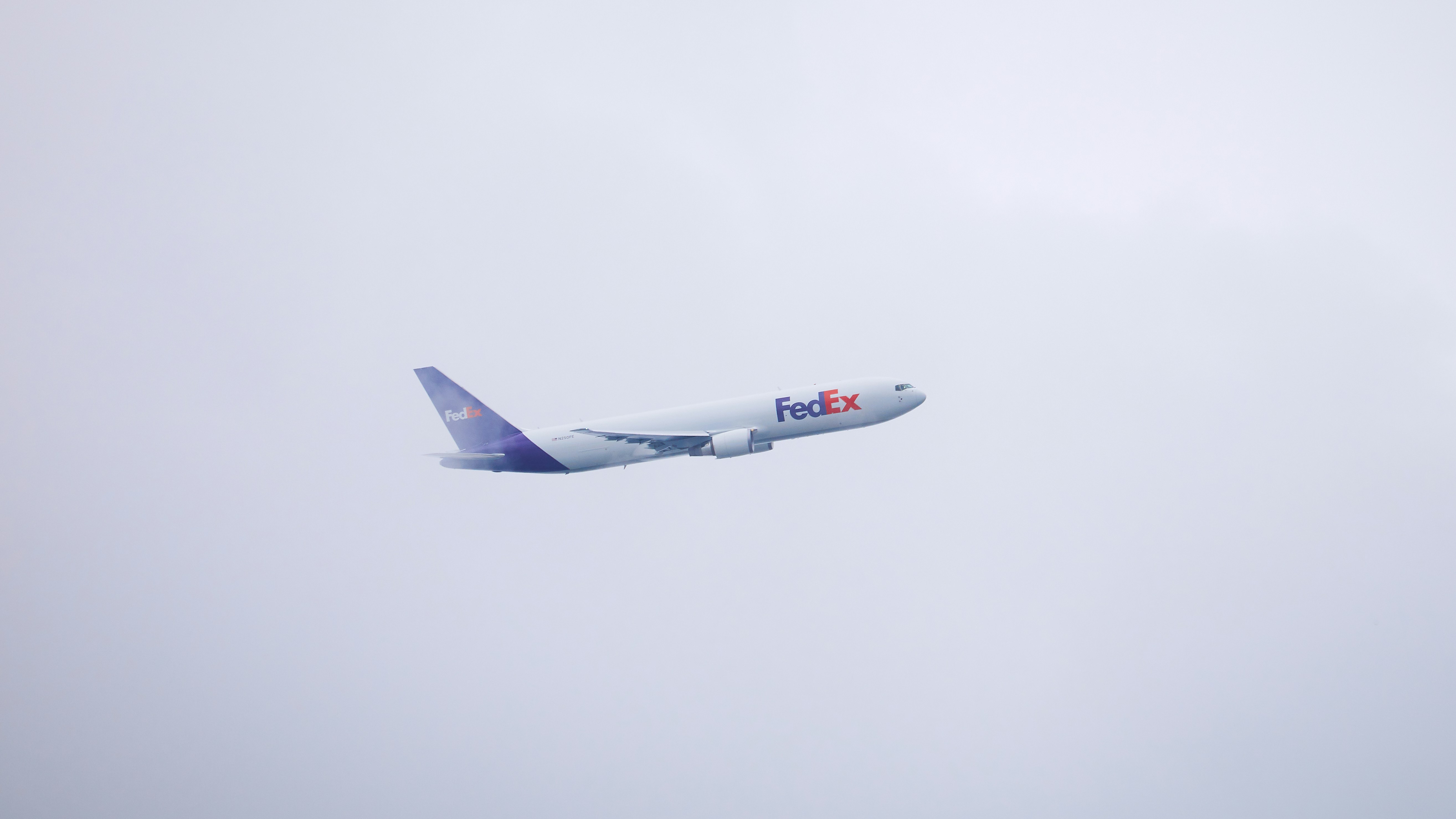 Fedex-Flugzeug steigt vor einem bewölkten Himmel auf